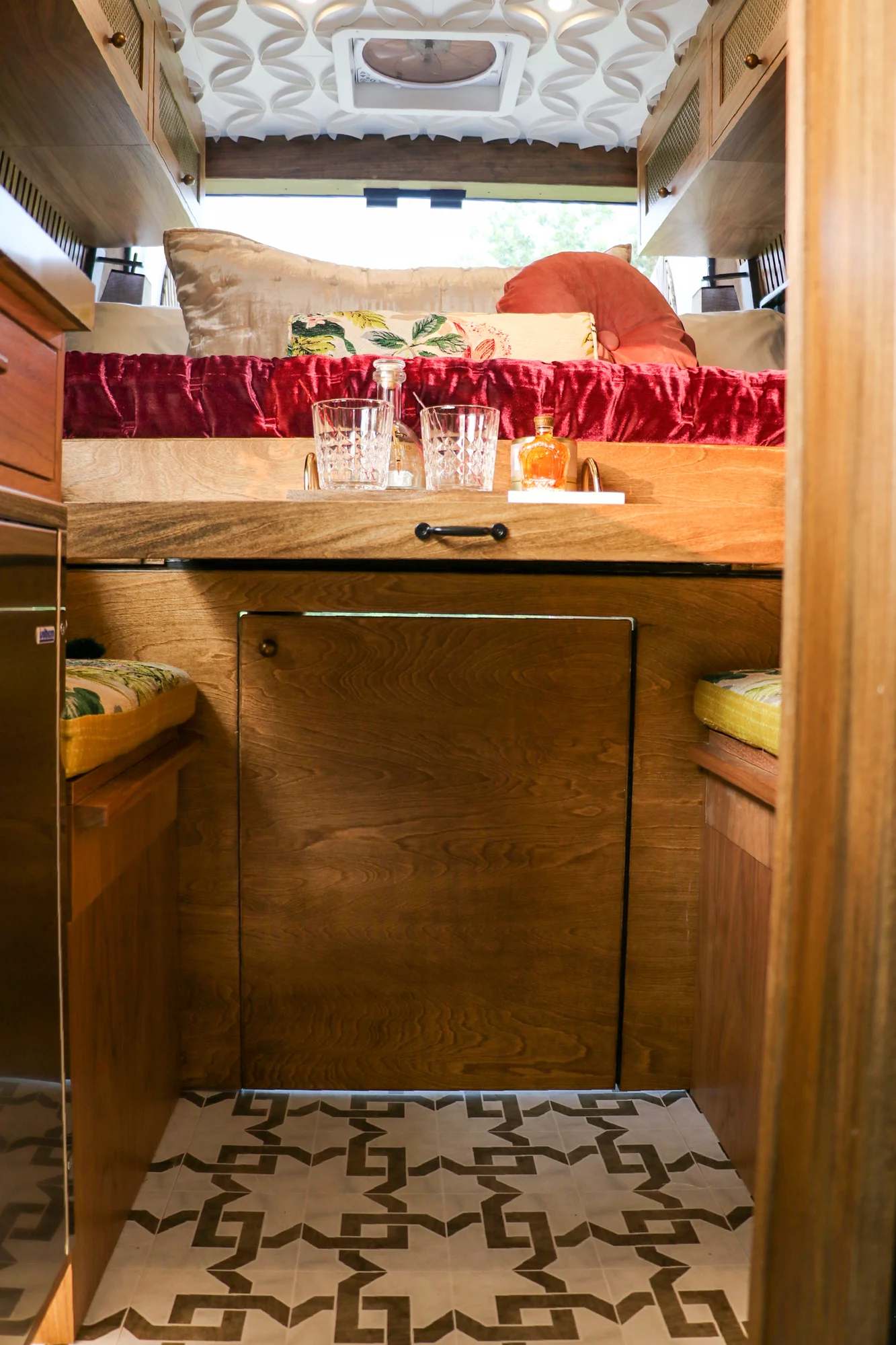 The Drifter 101 custom Ram ProMaster campervan built for Stephanie by Drifter Vans, Nomadik layout with a retro interior, velvet bedding, floral textiles, and brass fixtures