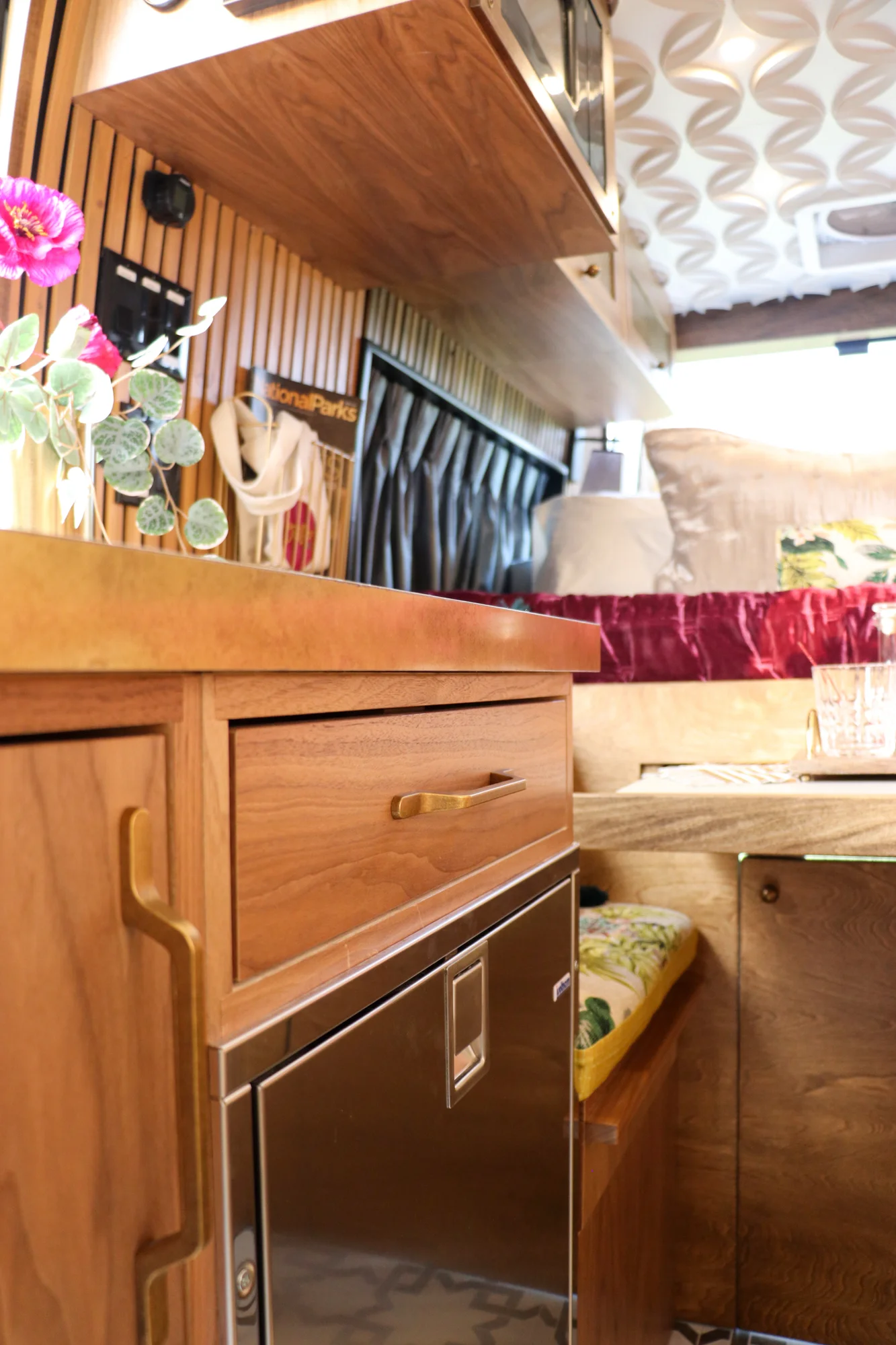 The Drifter 101 custom Ram ProMaster campervan built for Stephanie by Drifter Vans, Nomadik layout with a retro interior, velvet bedding, floral textiles, and brass fixtures
