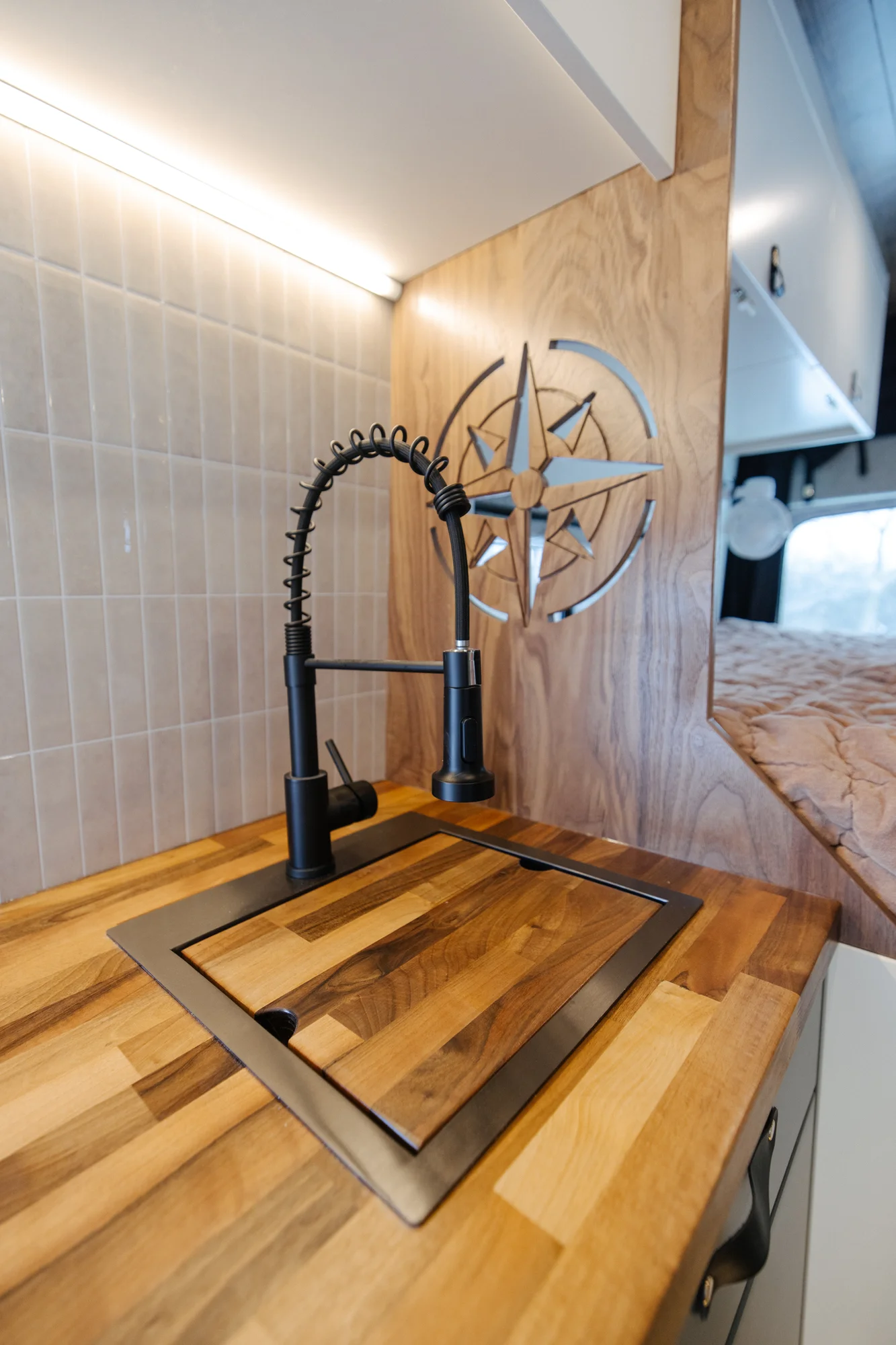 The Drifter 101 custom Ford Transit campervan built for Agnes by Drifter Vans, Drifter layout with sage green cabinetry, a Tetra shower, and Trelino composting toilet