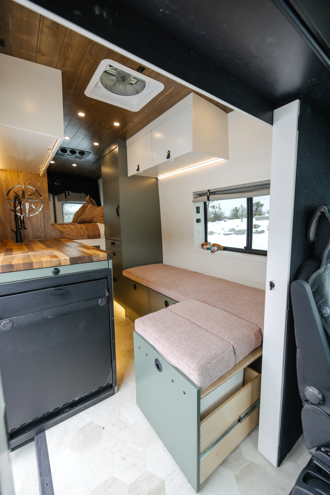 The Drifter 101 custom Ford Transit campervan built for Agnes by Drifter Vans, Drifter layout with sage green cabinetry, a Tetra shower, and Trelino composting toilet