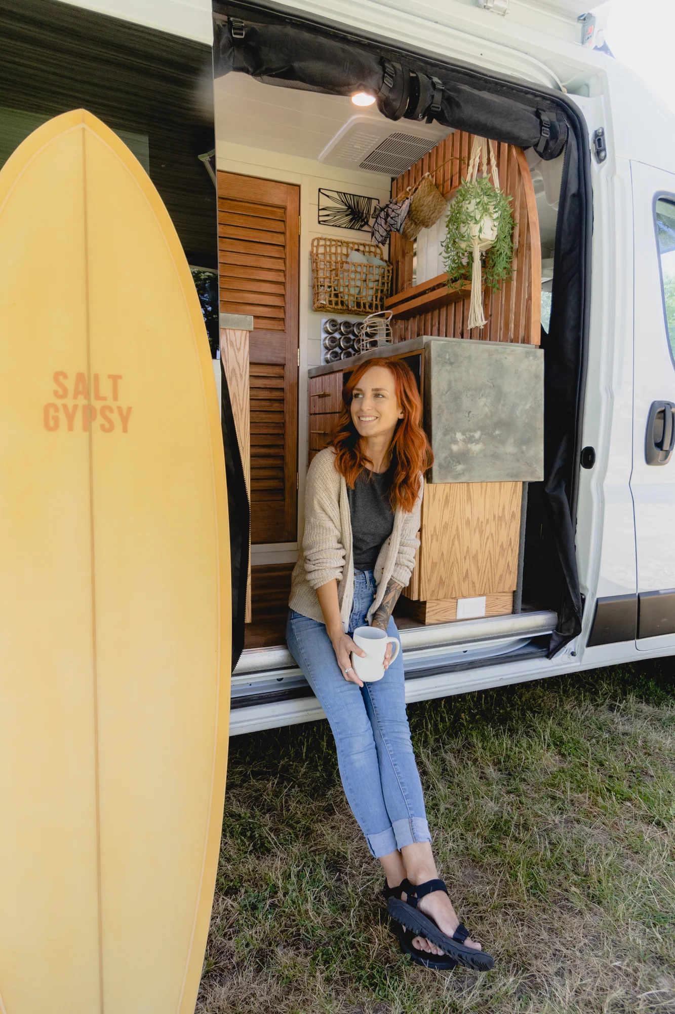 The Drifter 101 custom Ram ProMaster campervan built for Tracy by Drifter Vans, with an earthy boho interior, gold showerhead, and warm wood paneling