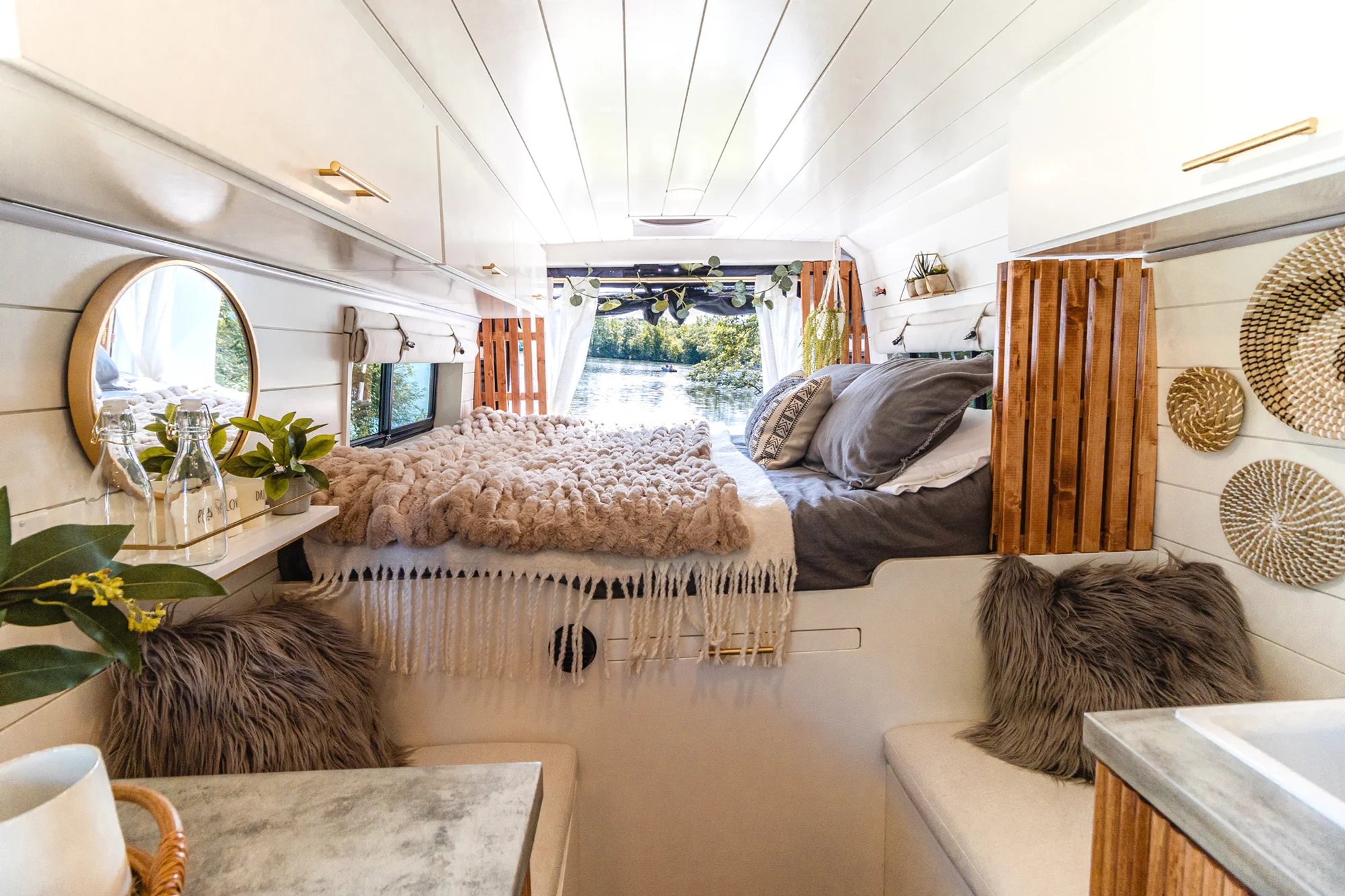 The Drifter 101 custom Ram ProMaster campervan built for Tracy by Drifter Vans, with an earthy boho interior, gold showerhead, and warm wood paneling