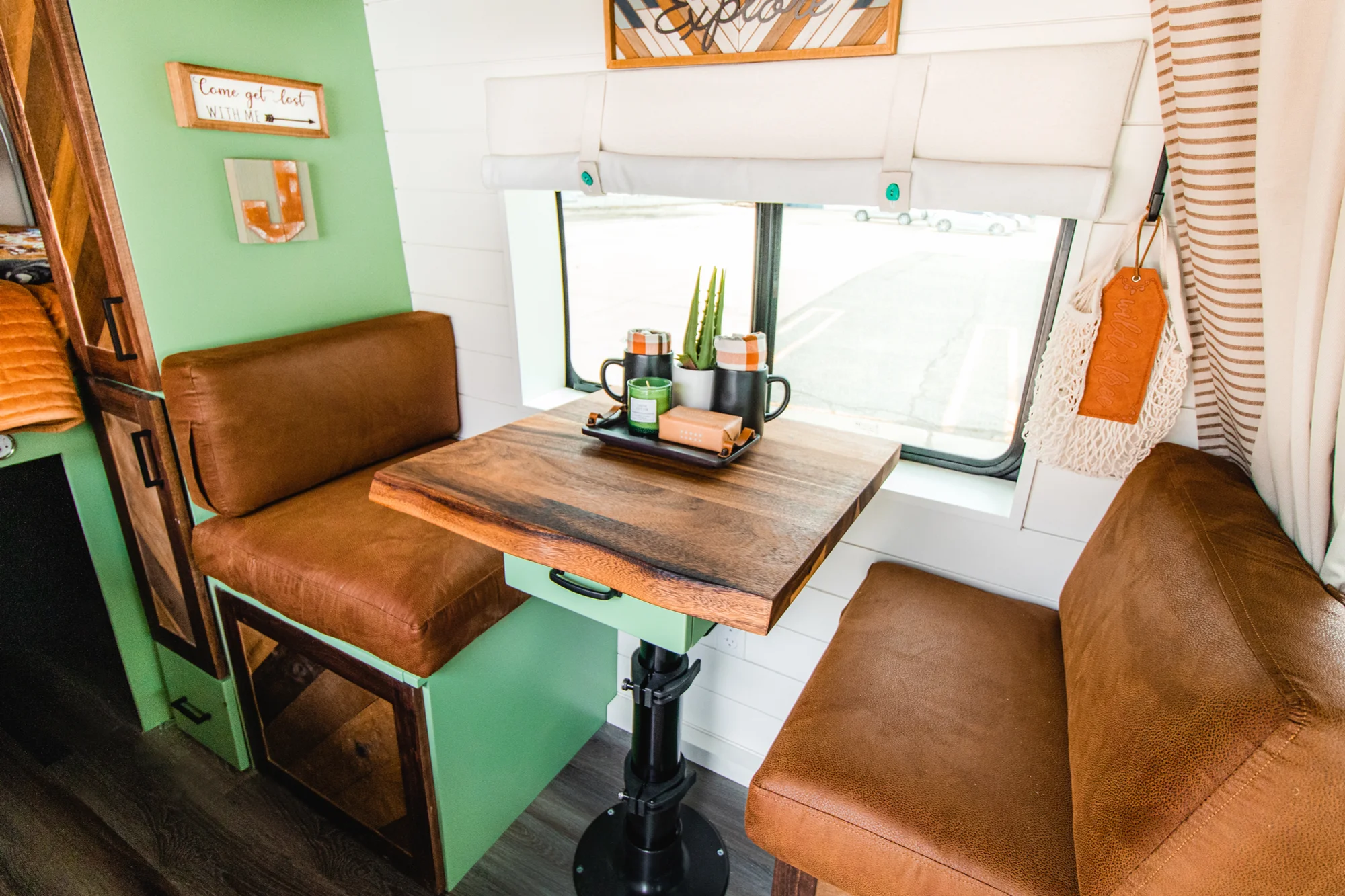 The Drifter 101 custom Ford Transit campervan built for Josh by Drifter Vans, Wanderer layout with forest green cabinetry, dark wood countertop, and leather booth seating