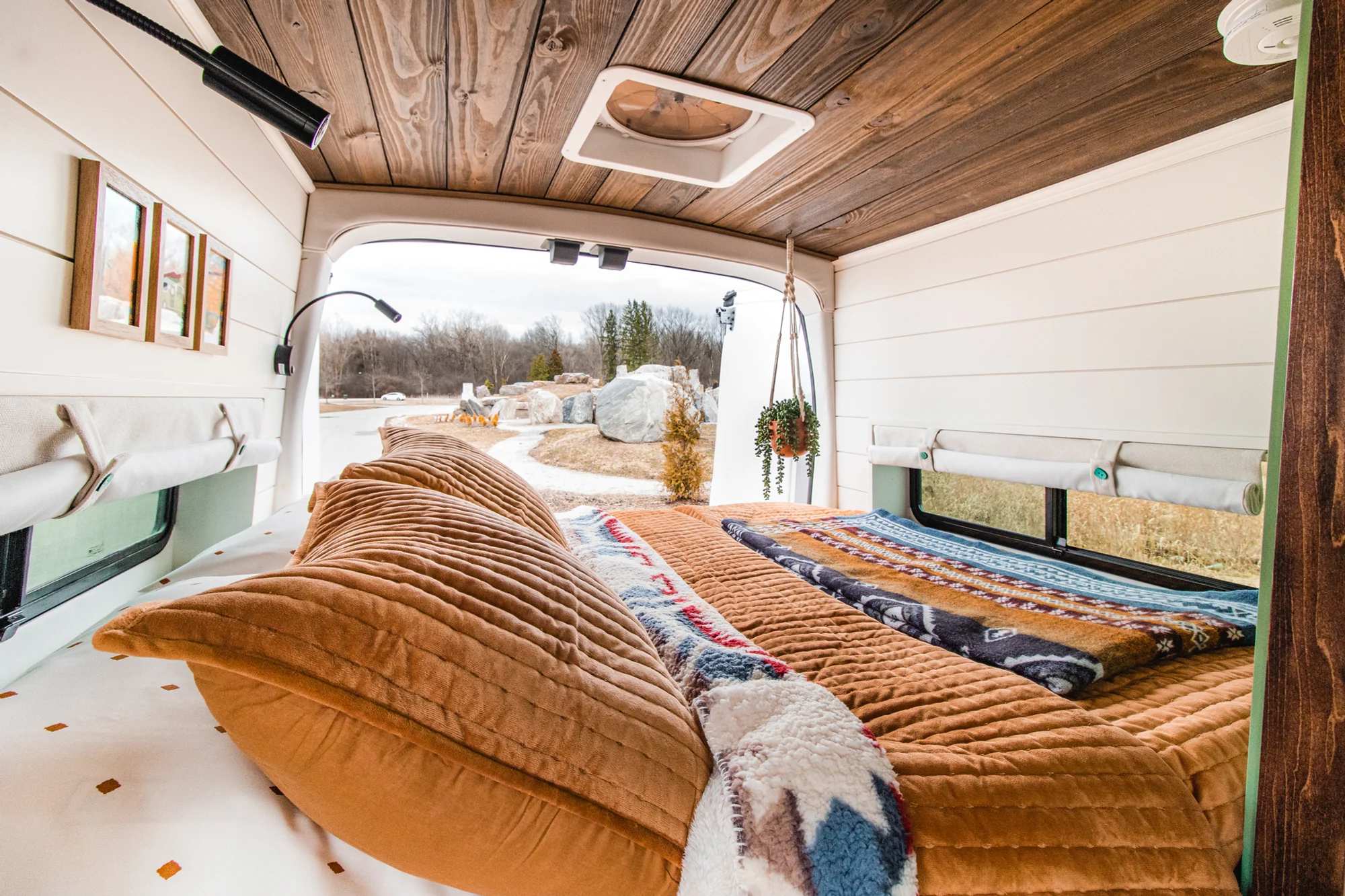 The Drifter 101 custom Ford Transit campervan built for Josh by Drifter Vans, Wanderer layout with forest green cabinetry, dark wood countertop, and leather booth seating