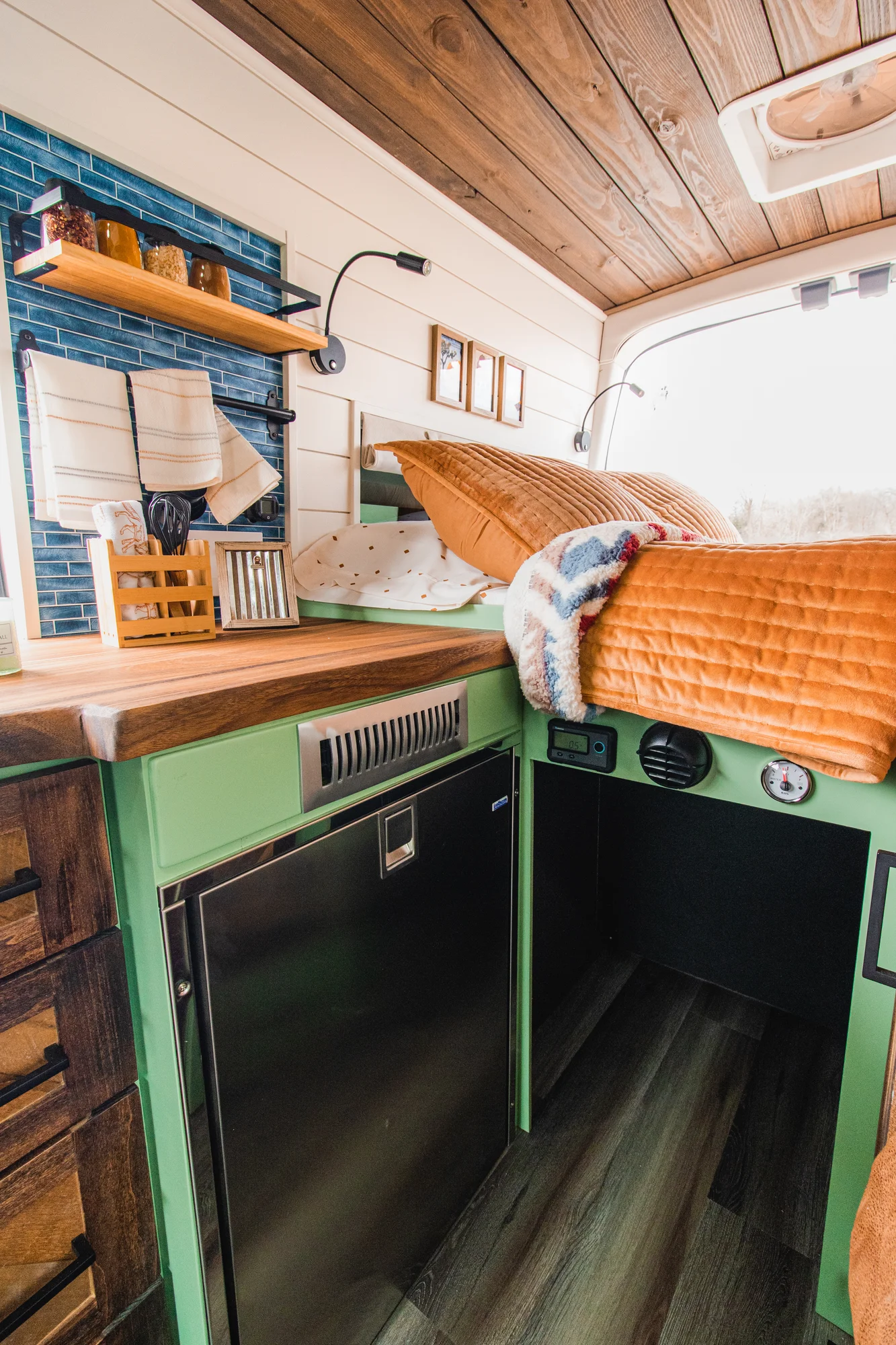 The Drifter 101 custom Ford Transit campervan built for Josh by Drifter Vans, Wanderer layout with forest green cabinetry, dark wood countertop, and leather booth seating