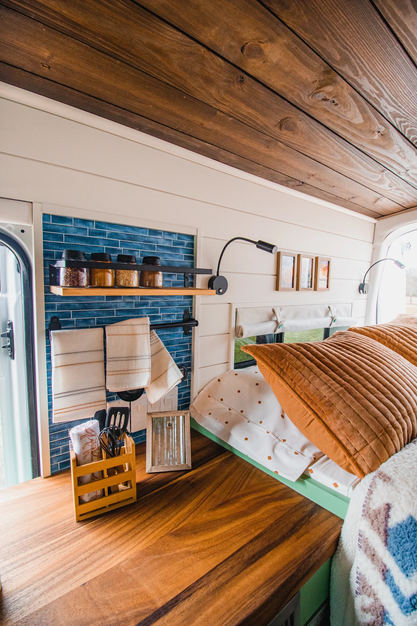 The Drifter 101 custom Ford Transit campervan built for Josh by Drifter Vans, Wanderer layout with forest green cabinetry, dark wood countertop, and leather booth seating