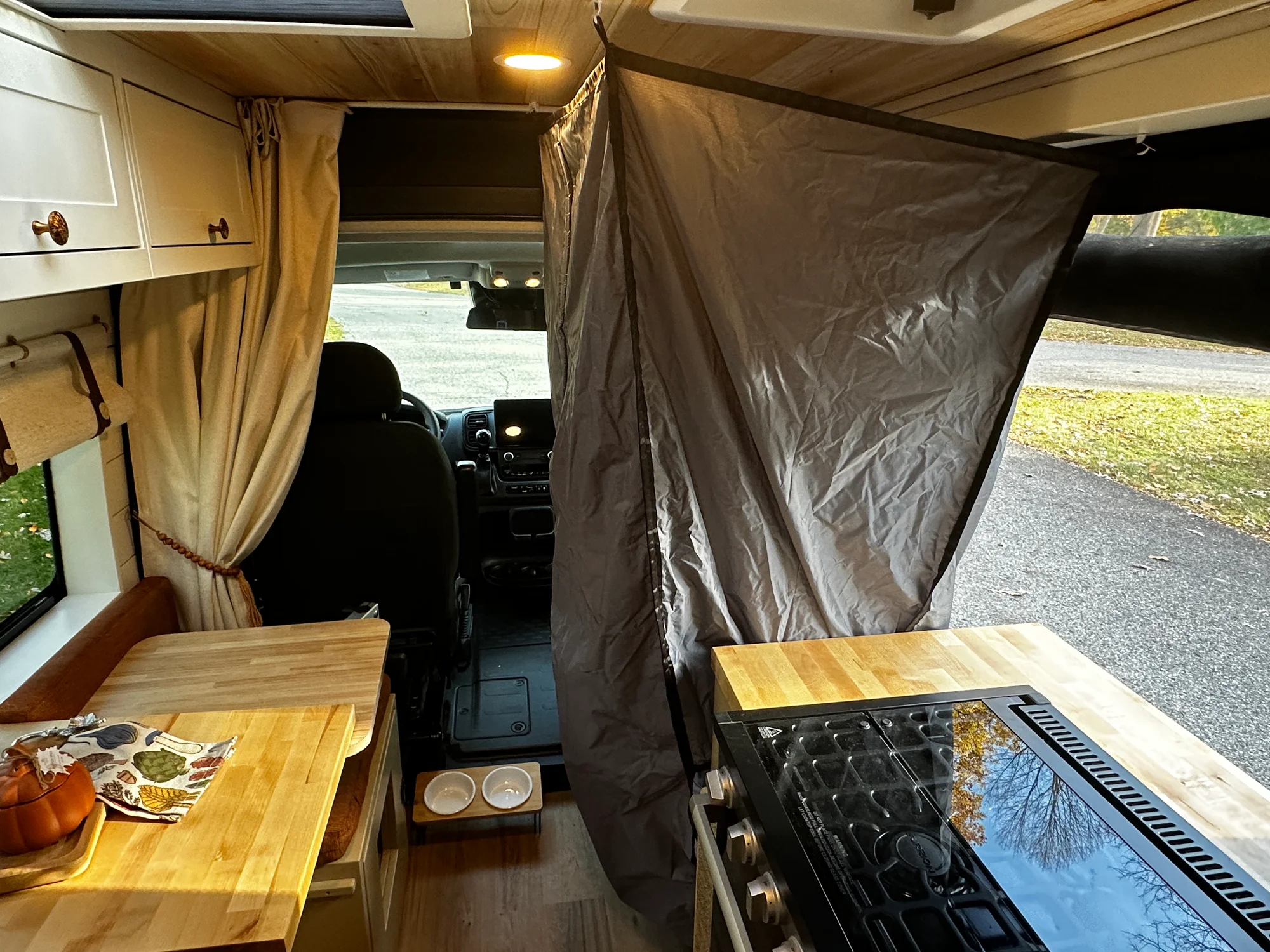 The Drifter 101 custom Ram ProMaster campervan built for Luke and Ashley by Drifter Vans, Drifter layout with a farmhouse interior, butcher block countertop, and wood ceiling