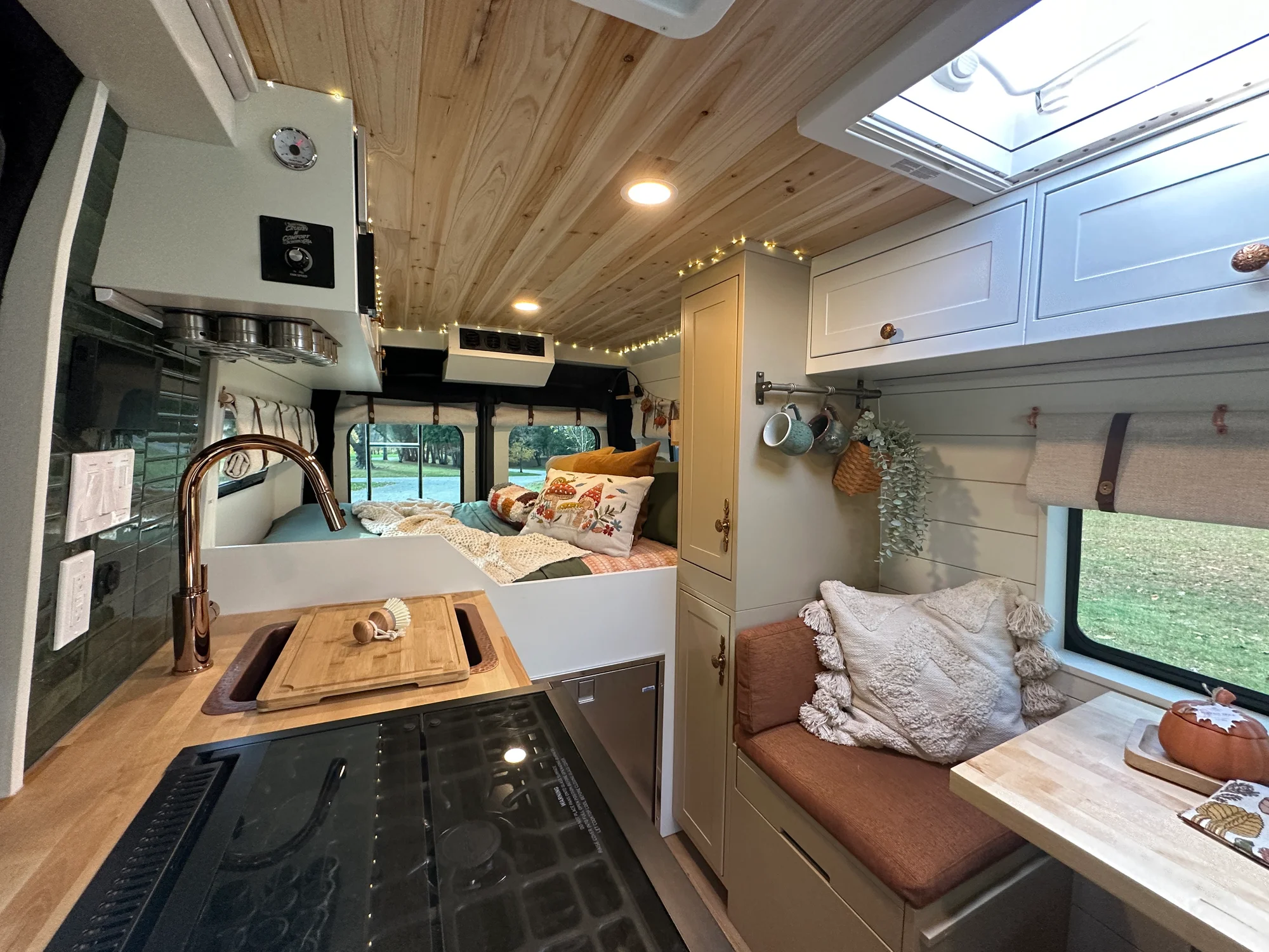 The Drifter 101 custom Ram ProMaster campervan built for Luke and Ashley by Drifter Vans, Drifter layout with a farmhouse interior, butcher block countertop, and wood ceiling