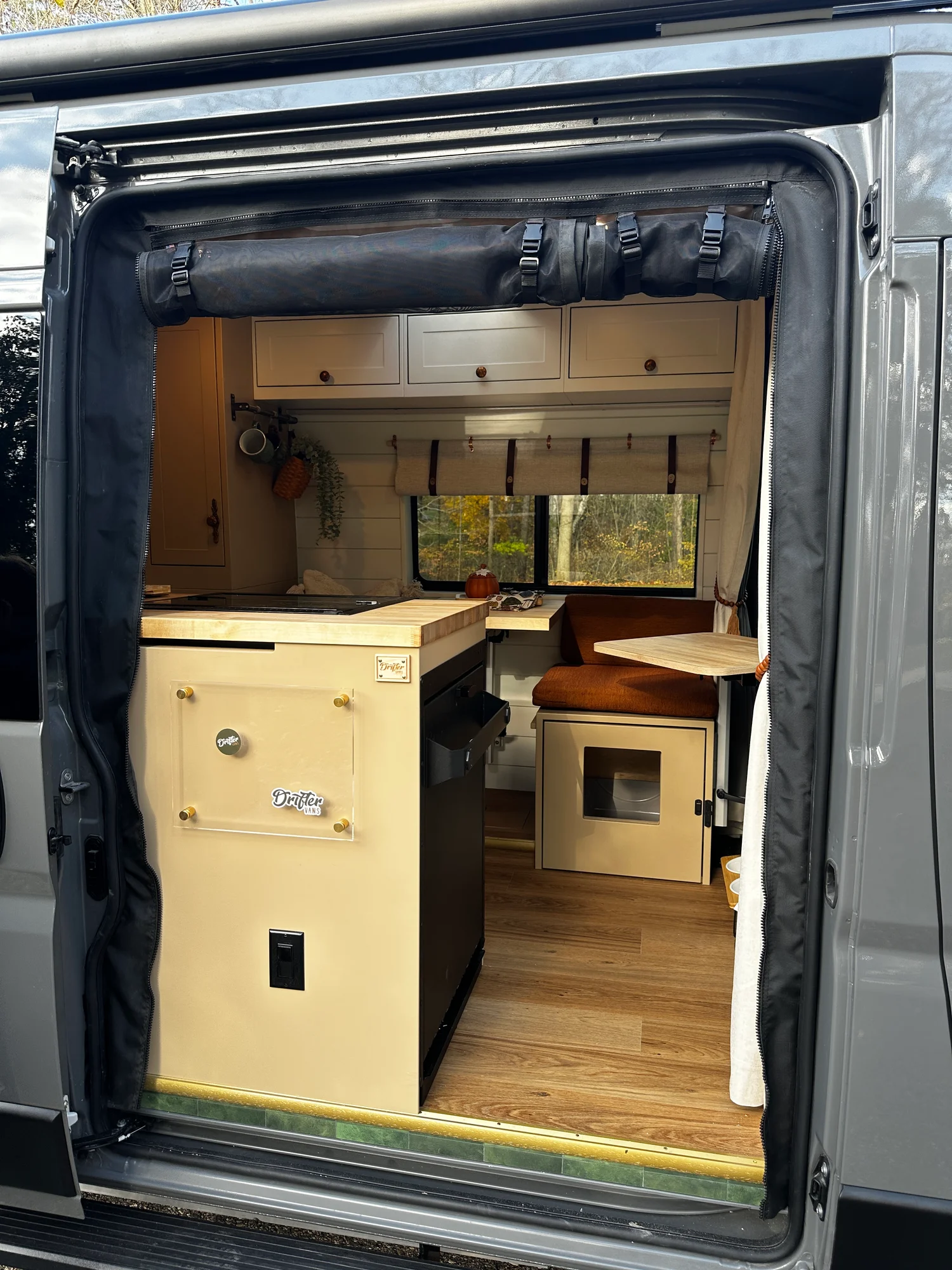 The Drifter 101 custom Ram ProMaster campervan built for Luke and Ashley by Drifter Vans, Drifter layout with a farmhouse interior, butcher block countertop, and wood ceiling