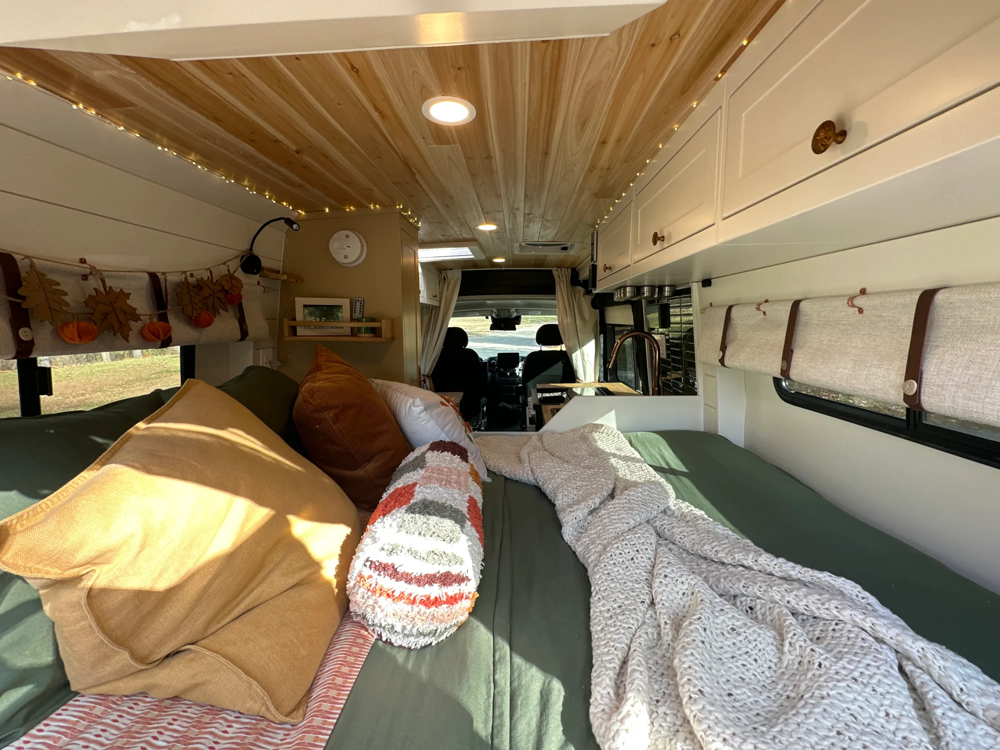 The Drifter 101 custom Ram ProMaster campervan built for Luke and Ashley by Drifter Vans, Drifter layout with a farmhouse interior, butcher block countertop, and wood ceiling