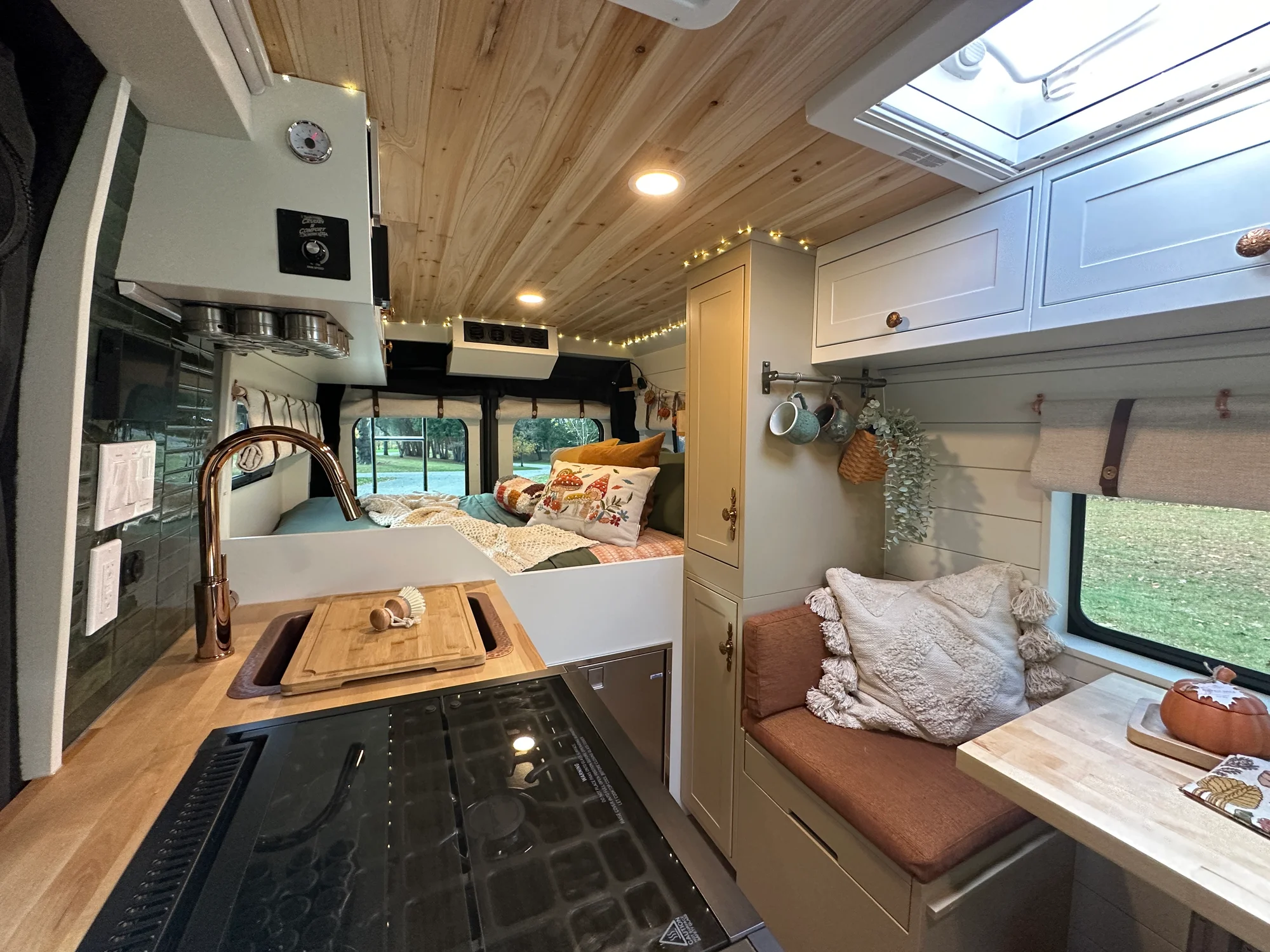 The Drifter 101 custom Ram ProMaster campervan built for Luke and Ashley by Drifter Vans, Drifter layout with a farmhouse interior, butcher block countertop, and wood ceiling
