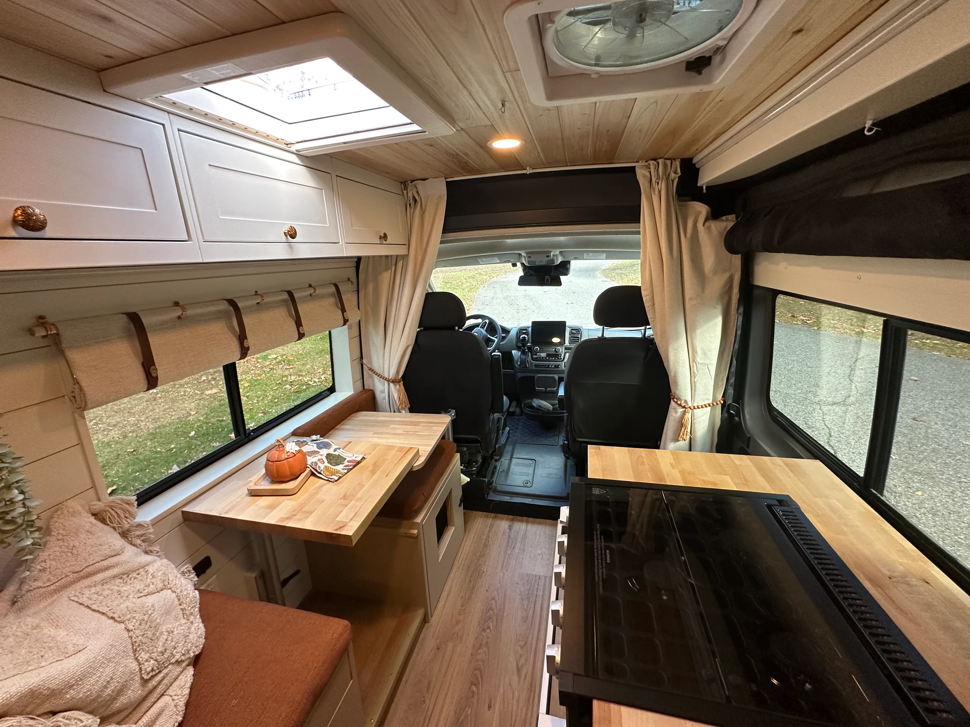 The Drifter 101 custom Ram ProMaster campervan built for Luke and Ashley by Drifter Vans, Drifter layout with a farmhouse interior, butcher block countertop, and wood ceiling