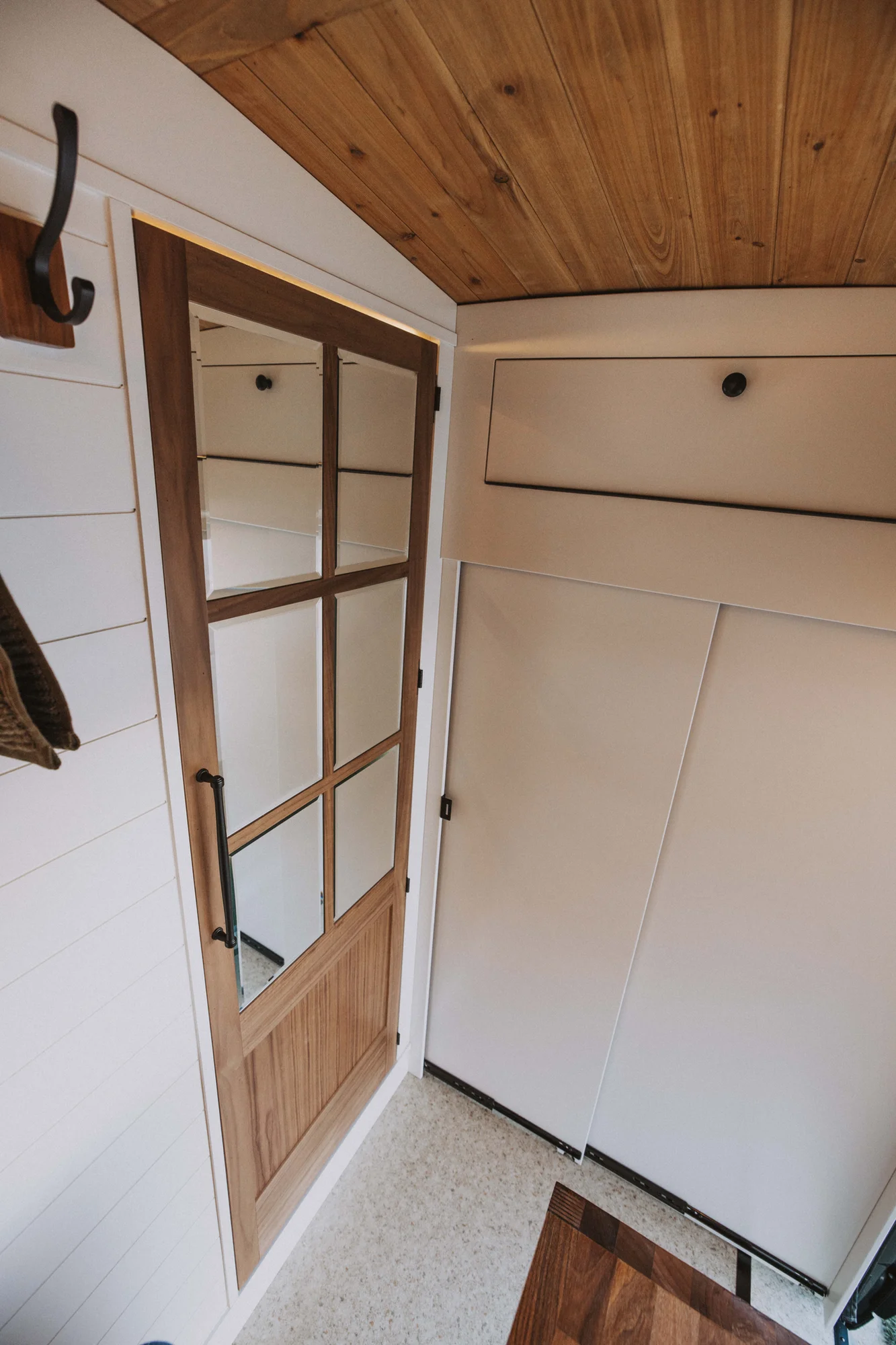 The Drifter 101 custom Ford Transit campervan built for Charlie and Linda by Drifter Vans, Nomadik layout with a Vermont slate shower, sky-blue cabinetry, and butcher block countertop