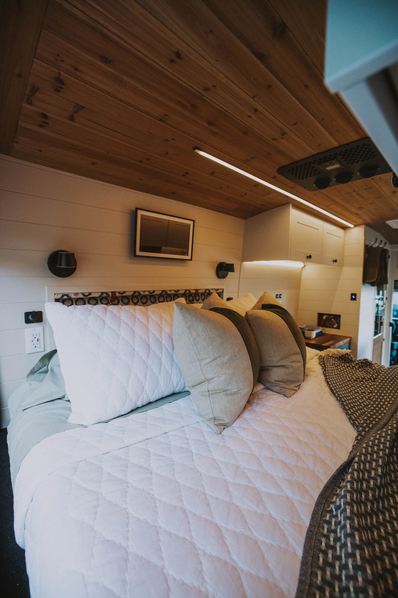 The Drifter 101 custom Ford Transit campervan built for Charlie and Linda by Drifter Vans, Nomadik layout with a Vermont slate shower, sky-blue cabinetry, and butcher block countertop