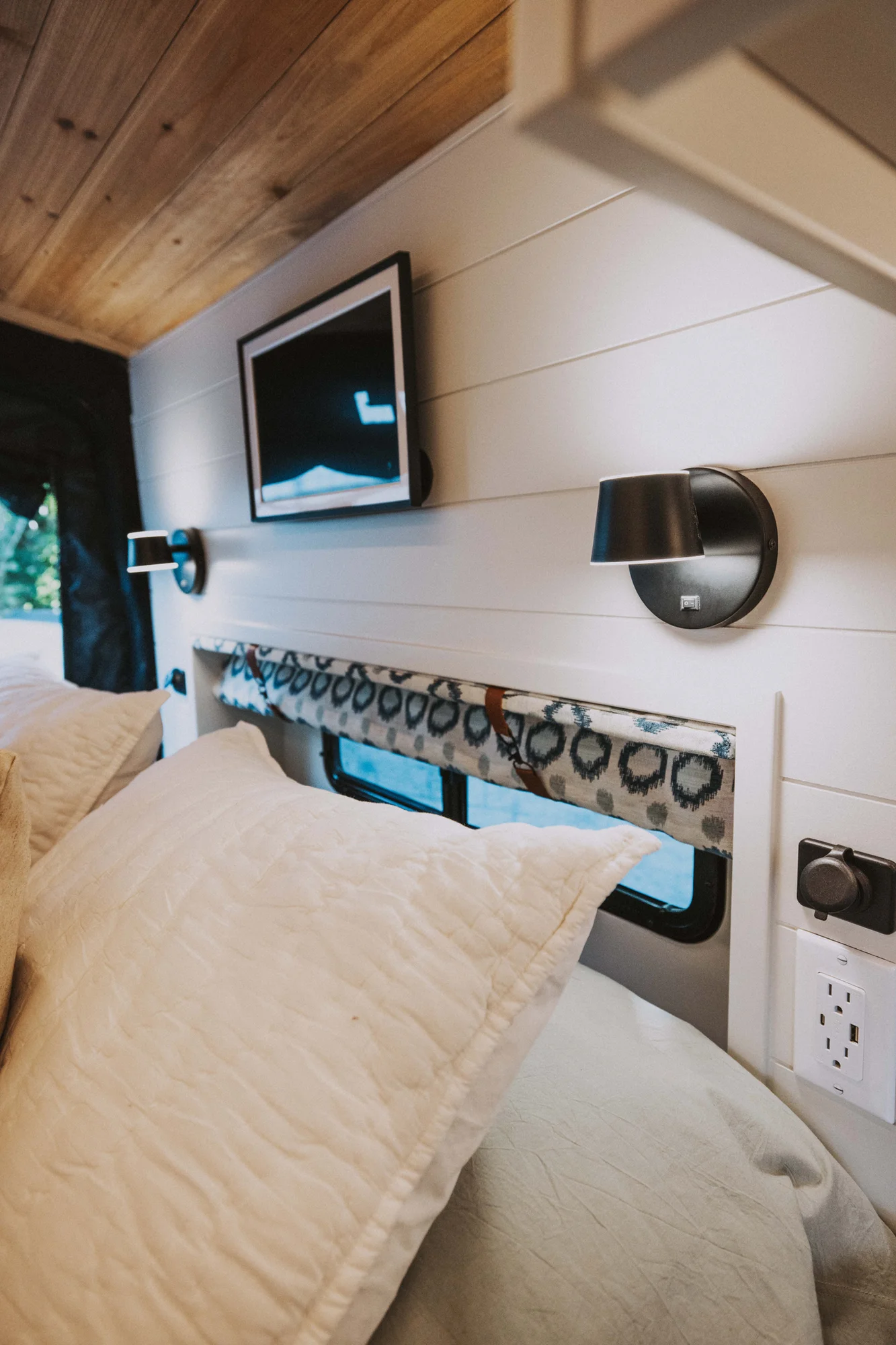 The Drifter 101 custom Ford Transit campervan built for Charlie and Linda by Drifter Vans, Nomadik layout with a Vermont slate shower, sky-blue cabinetry, and butcher block countertop