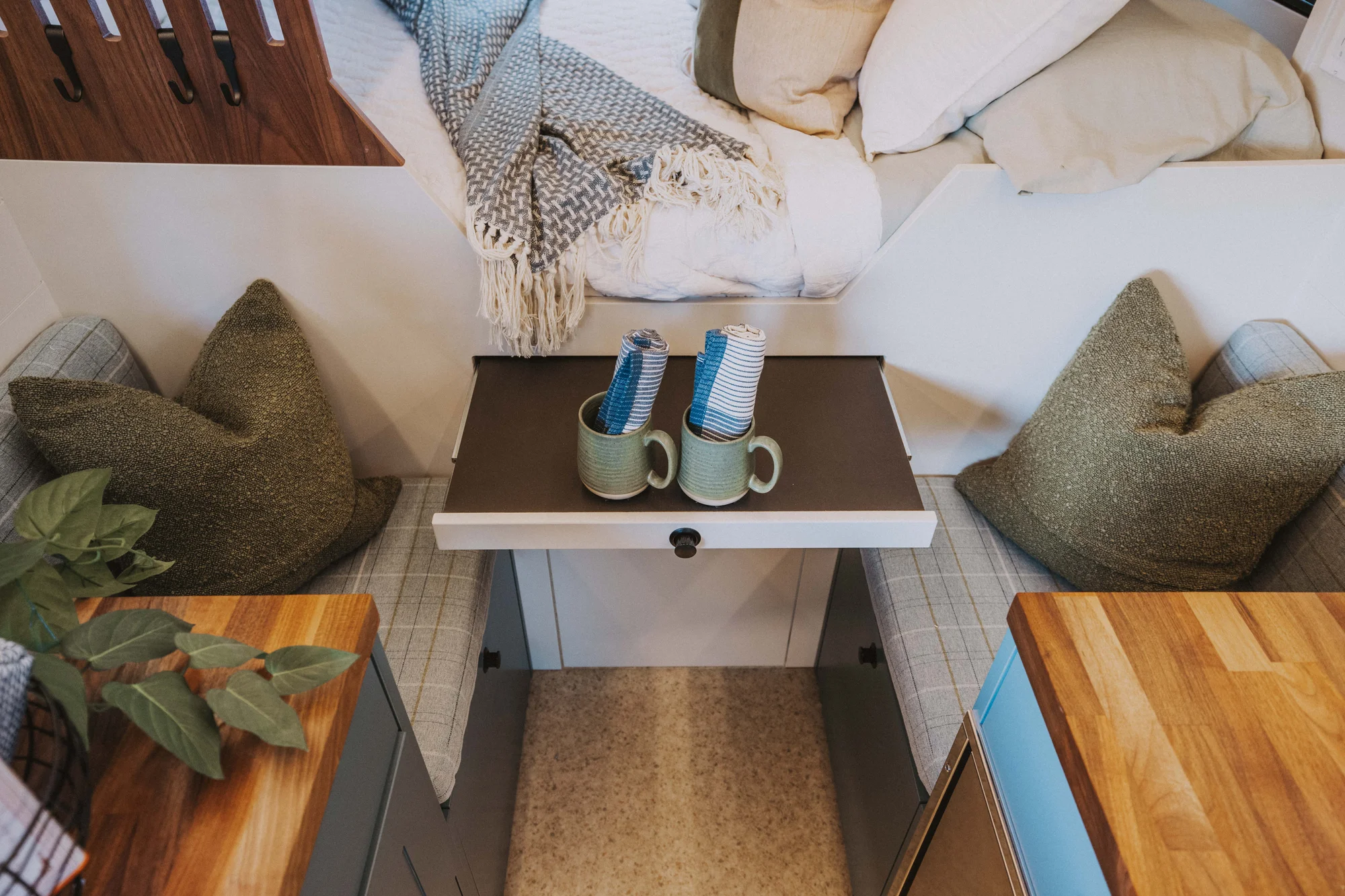 The Drifter 101 custom Ford Transit campervan built for Charlie and Linda by Drifter Vans, Nomadik layout with a Vermont slate shower, sky-blue cabinetry, and butcher block countertop