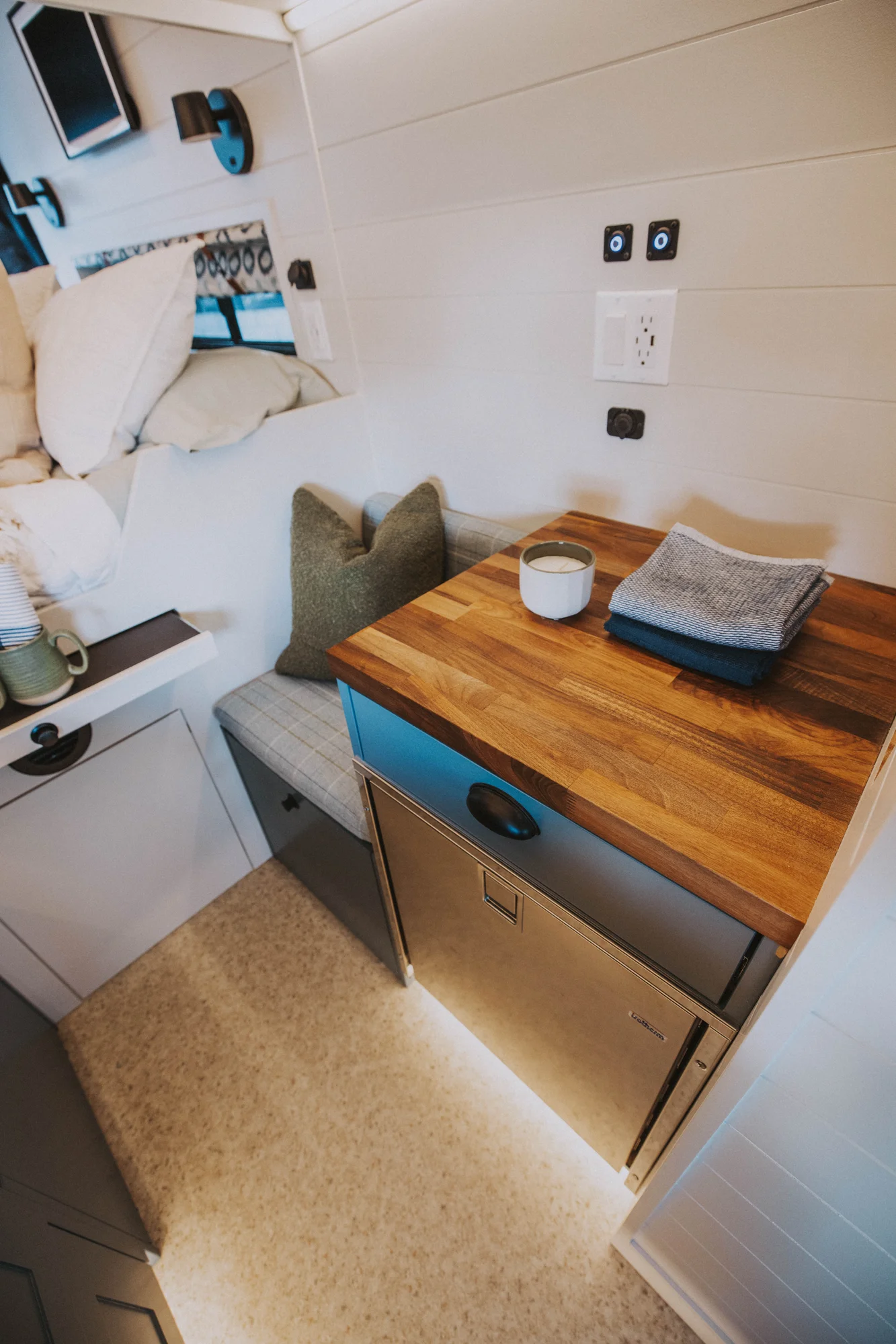 The Drifter 101 custom Ford Transit campervan built for Charlie and Linda by Drifter Vans, Nomadik layout with a Vermont slate shower, sky-blue cabinetry, and butcher block countertop
