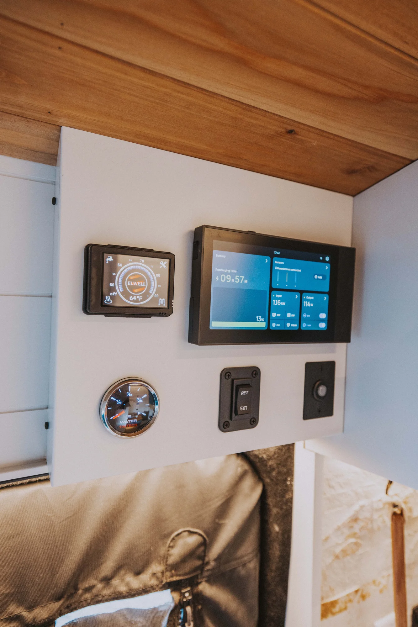 The Drifter 101 custom Ford Transit campervan built for Charlie and Linda by Drifter Vans, Nomadik layout with a Vermont slate shower, sky-blue cabinetry, and butcher block countertop