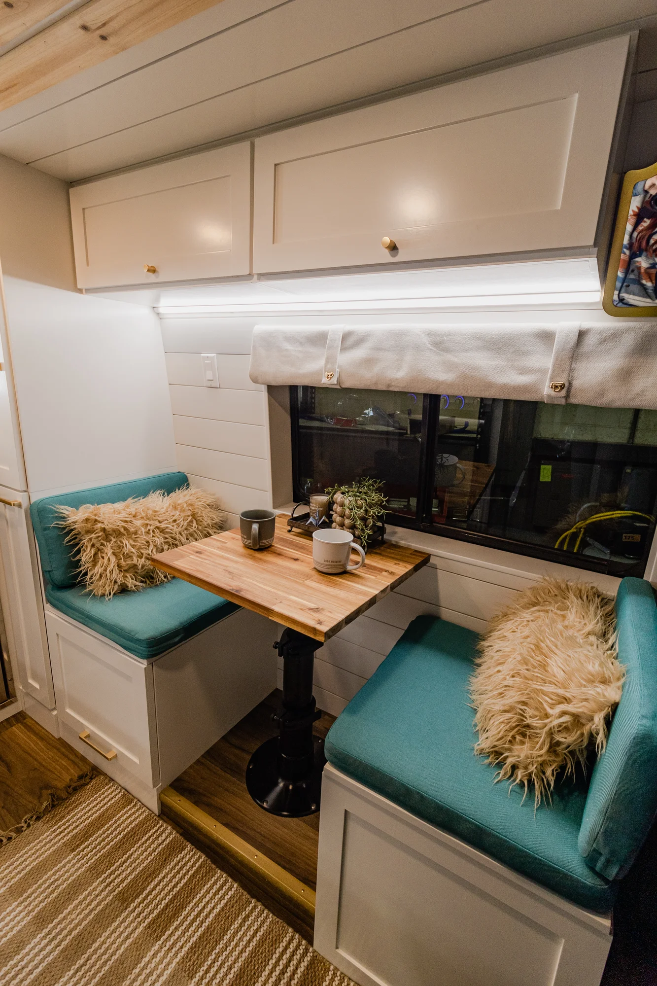 The Drifter 101 custom Ram ProMaster campervan built for Rhonda by Drifter Vans, Wanderer layout with a boho interior, Furrion oven, blue patterned tile backsplash, and brass hardware