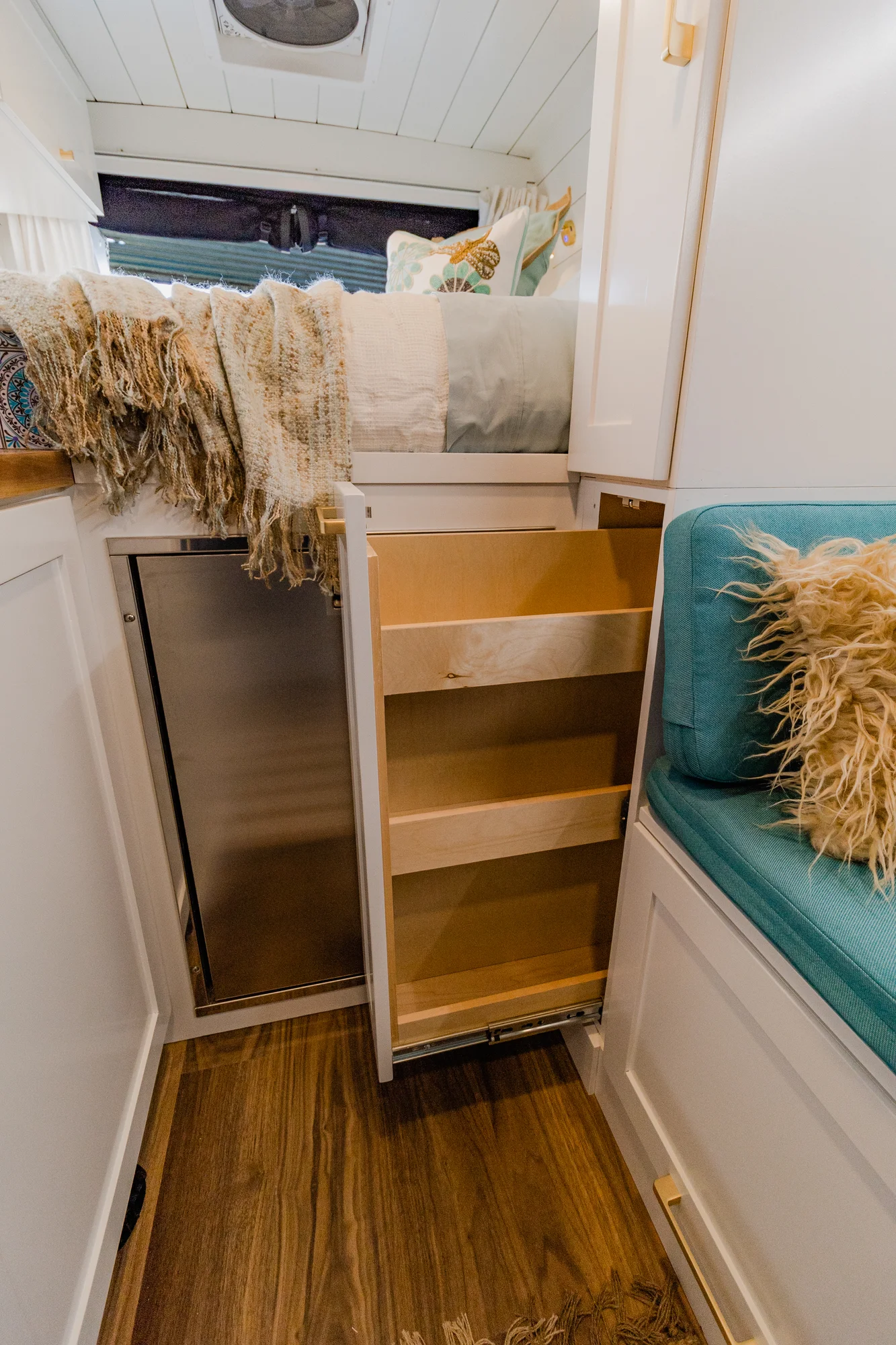 The Drifter 101 custom Ram ProMaster campervan built for Rhonda by Drifter Vans, Wanderer layout with a boho interior, Furrion oven, blue patterned tile backsplash, and brass hardware