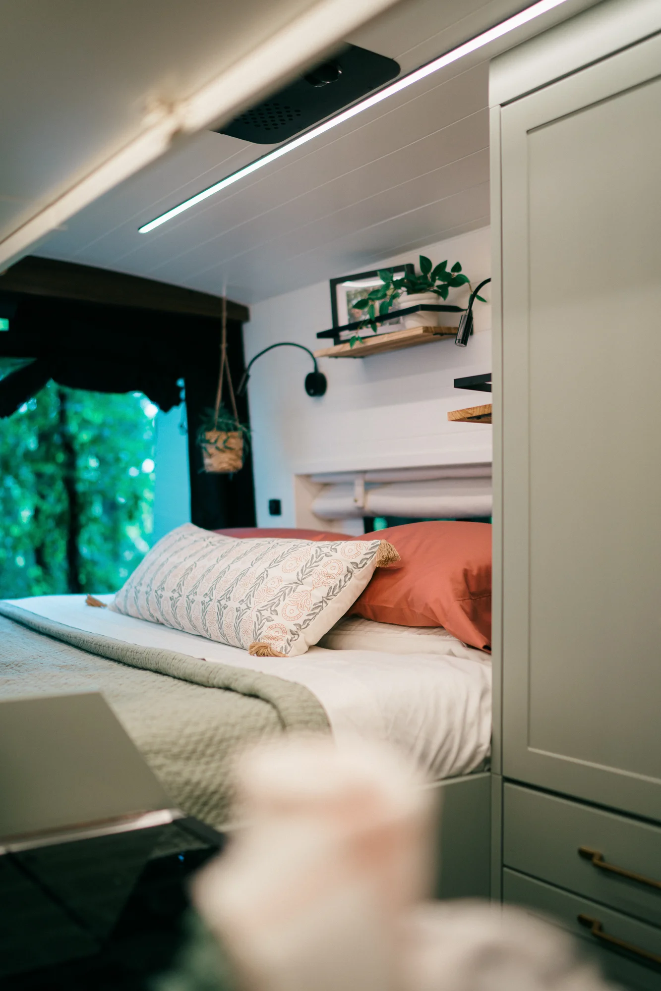 The Drifter 101 custom Ford Transit campervan built for Heather by Drifter Vans, Drifter layout with a full oven, patterned tile backsplash, brass faucet, and natural wood cabinetry