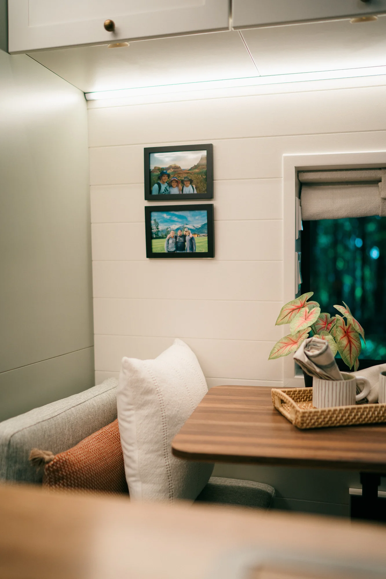 The Drifter 101 custom Ford Transit campervan built for Heather by Drifter Vans, Drifter layout with a full oven, patterned tile backsplash, brass faucet, and natural wood cabinetry