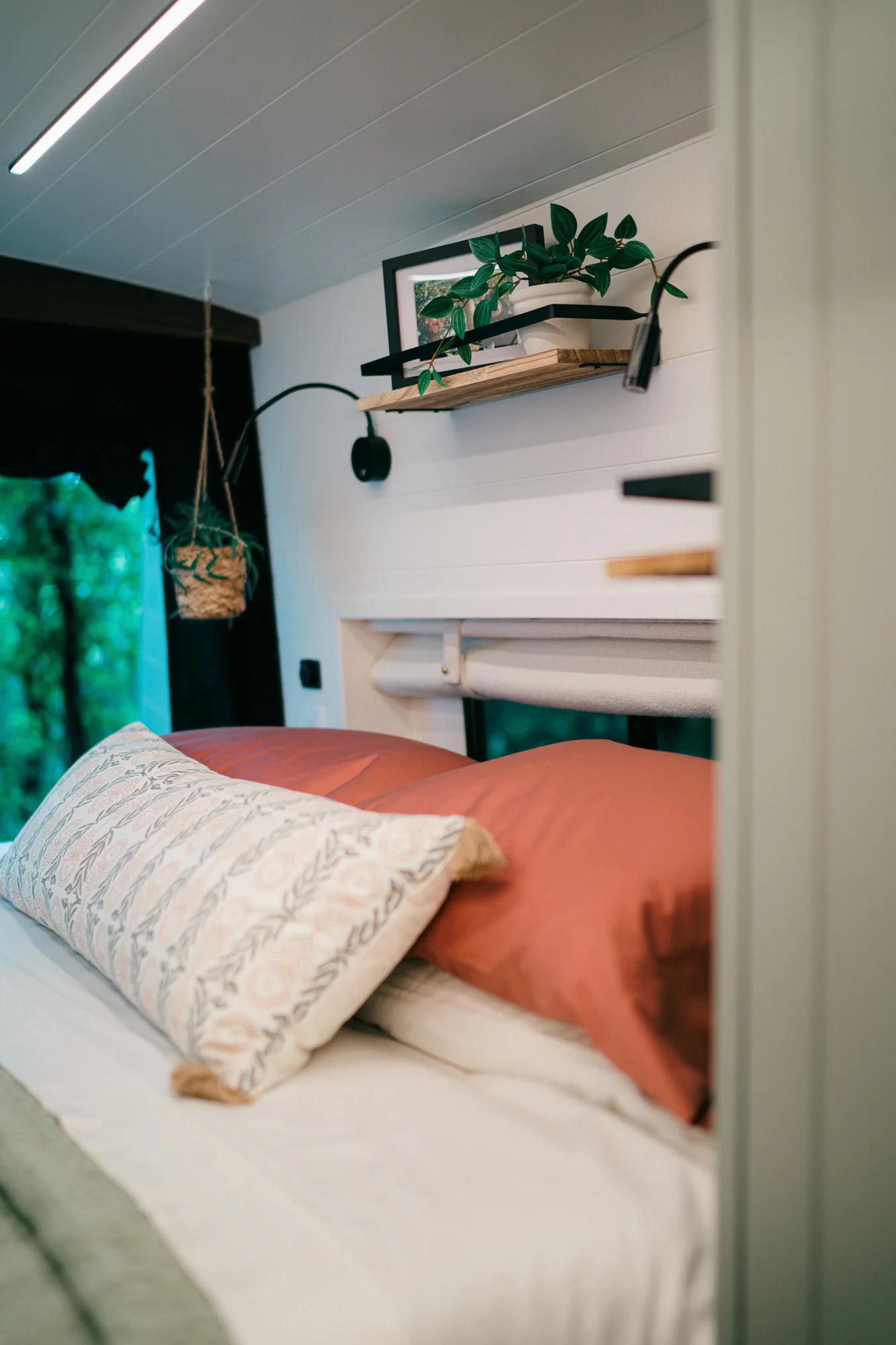 The Drifter 101 custom Ford Transit campervan built for Heather by Drifter Vans, Drifter layout with a full oven, patterned tile backsplash, brass faucet, and natural wood cabinetry