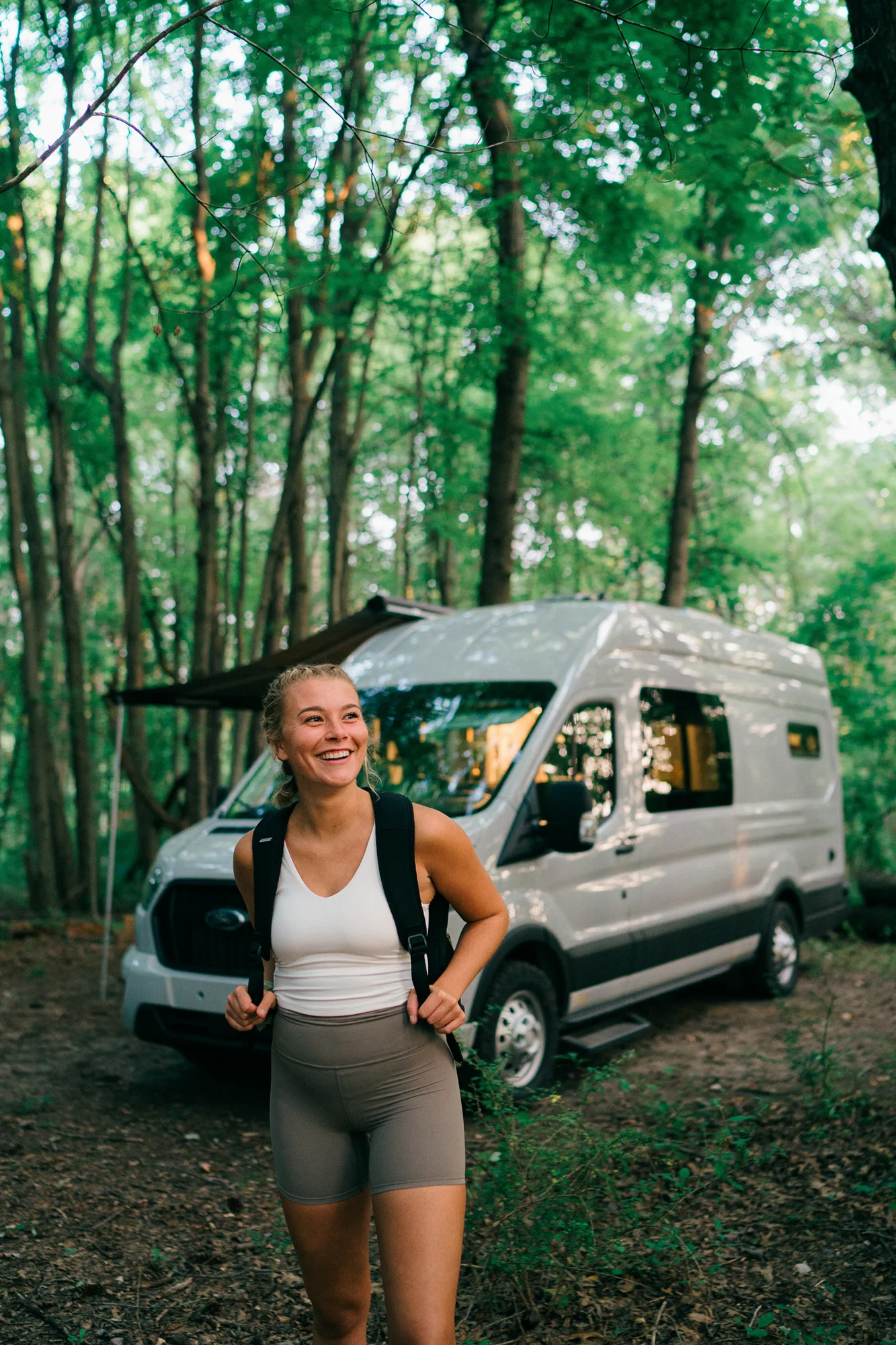The Drifter 101 custom Ford Transit campervan built for Heather by Drifter Vans, Drifter layout with a full oven, patterned tile backsplash, brass faucet, and natural wood cabinetry