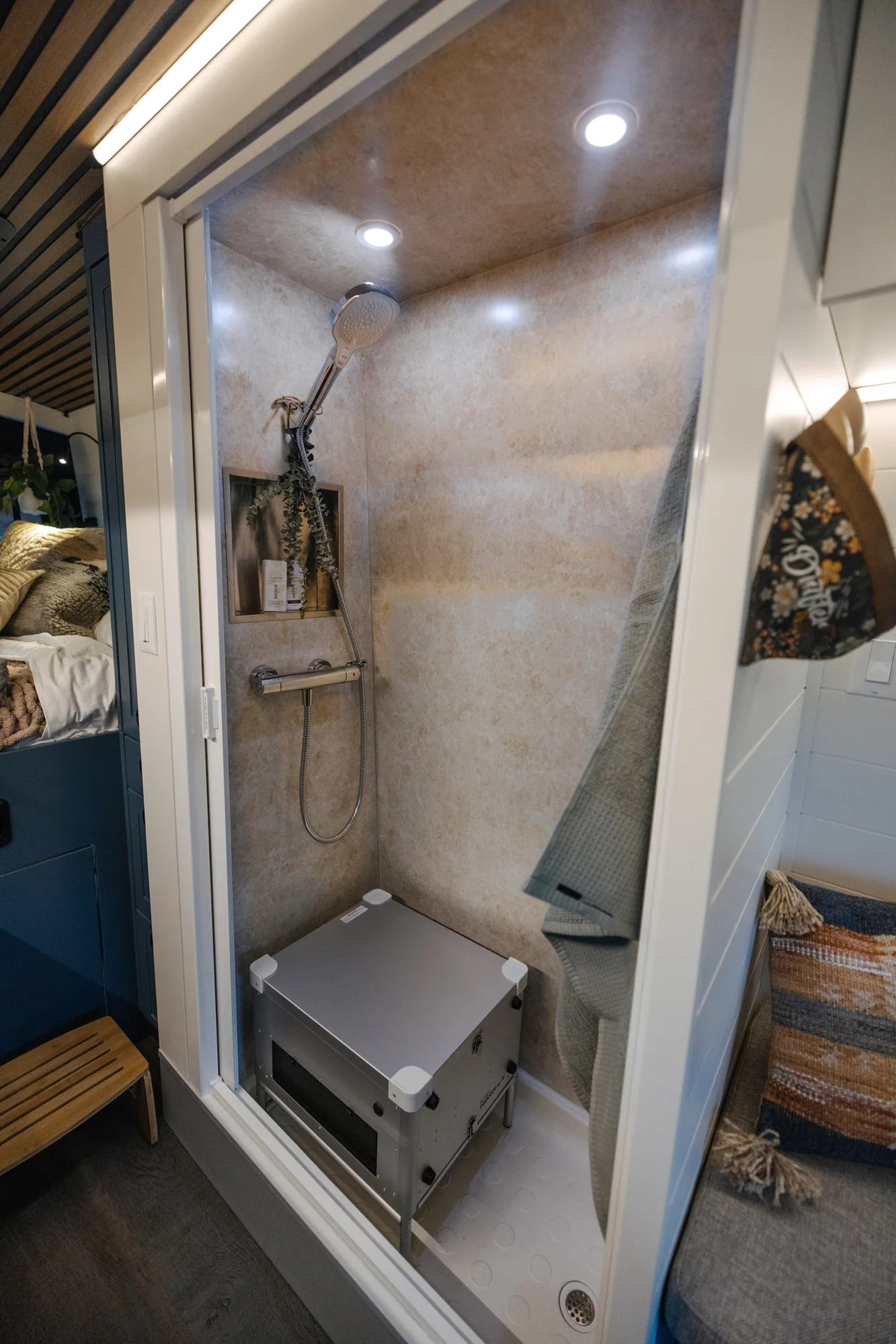 The Drifter 101 custom Ford Transit campervan built for Karen and Jerry by Drifter Vans, Scout layout with navy blue cabinetry, a mountain-engraved backsplash, and butcher block countertop