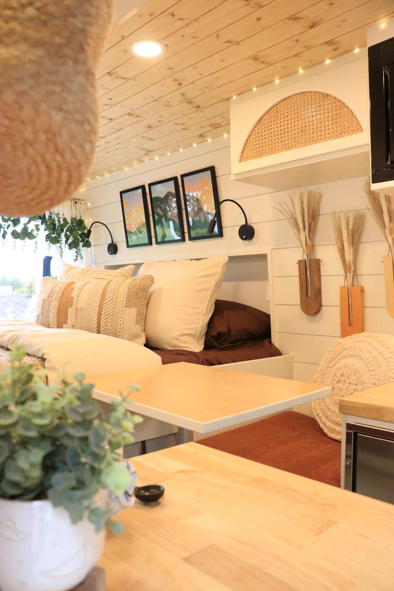 The Drifter 101 custom Ford Transit campervan built for Sarah by Drifter Vans, Nomadik layout with a marble-style wet bath, gold faucet, trifold privacy door, and boho accents