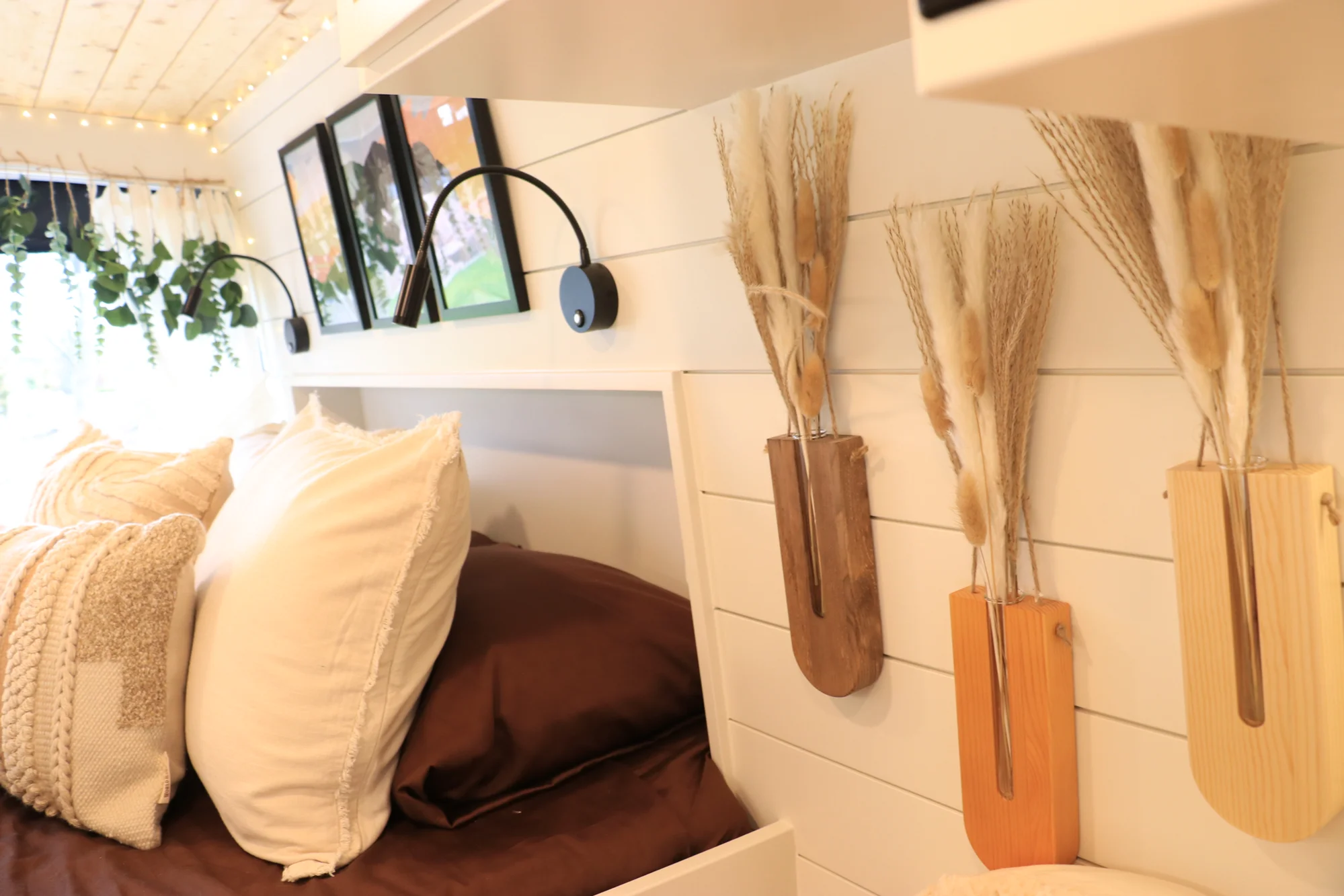 The Drifter 101 custom Ford Transit campervan built for Sarah by Drifter Vans, Nomadik layout with a marble-style wet bath, gold faucet, trifold privacy door, and boho accents