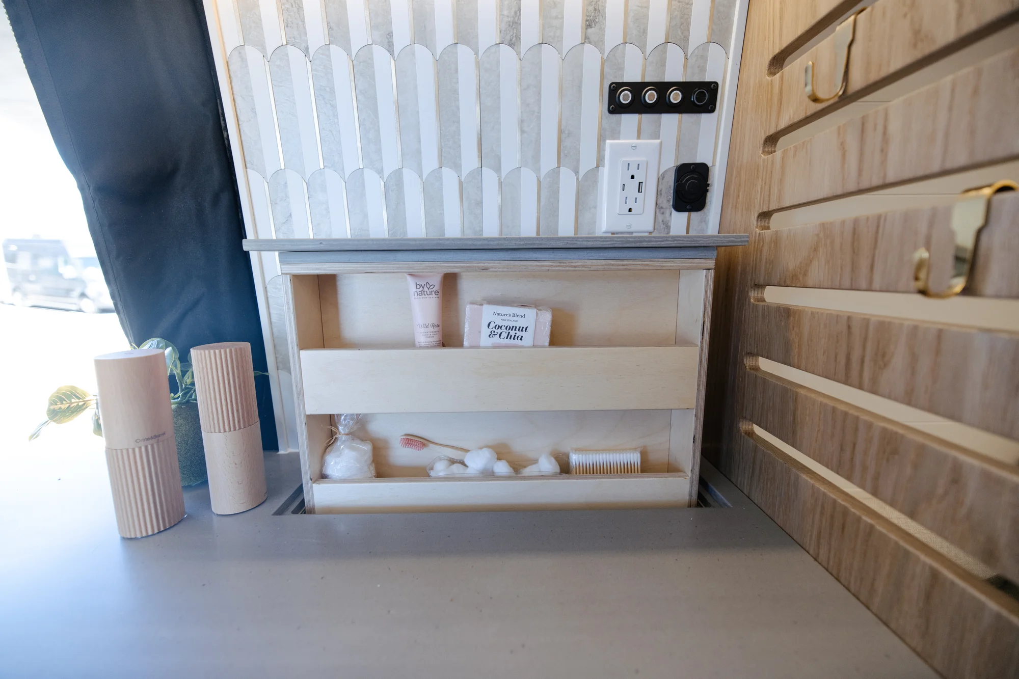 The Drifter 101 custom Ford Transit campervan built for Alison by Drifter Vans, Nomadik layout with a Japandi interior, white cabinetry, gold rain shower, and marble wet bath