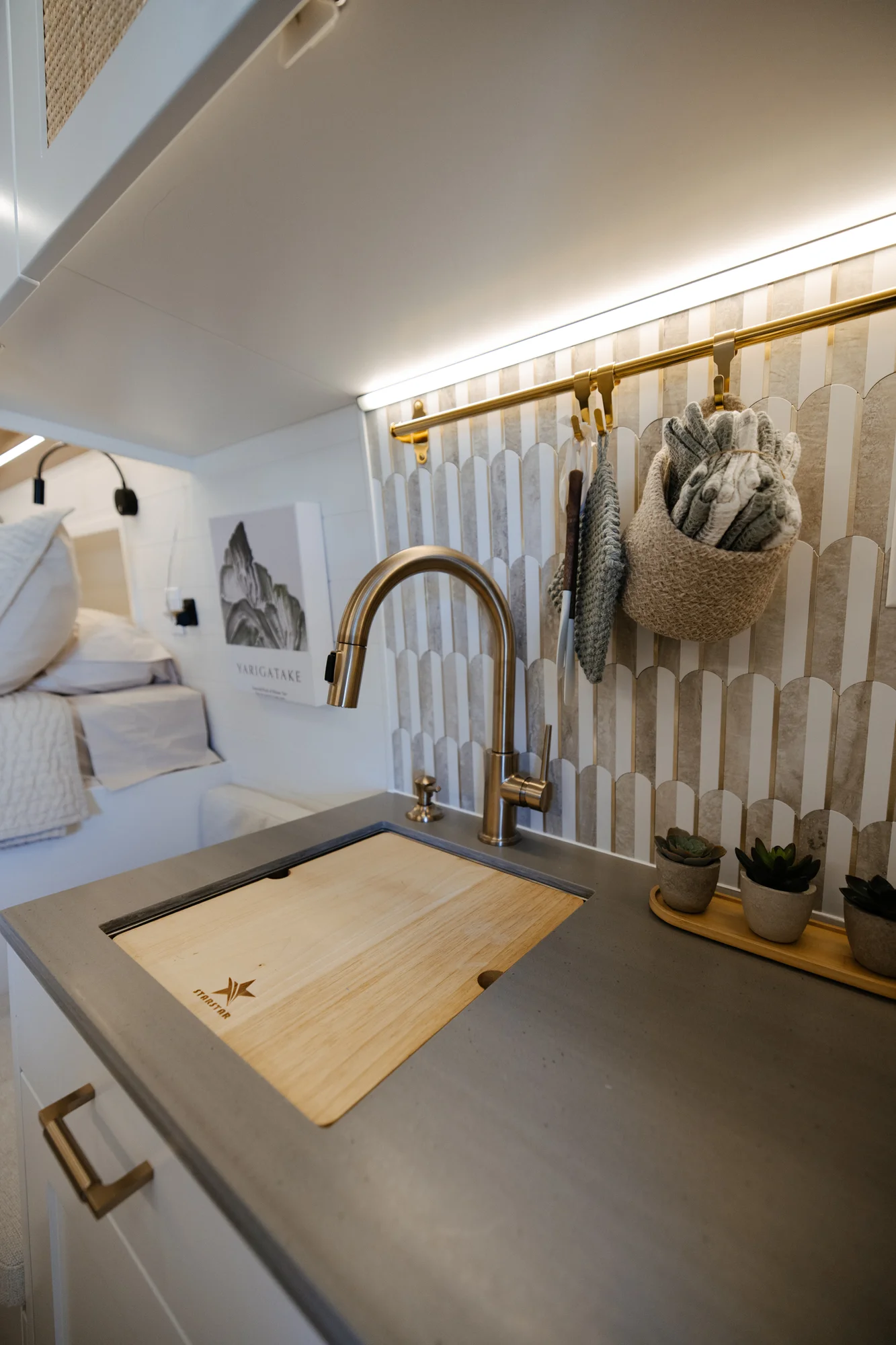 The Drifter 101 custom Ford Transit campervan built for Alison by Drifter Vans, Nomadik layout with a Japandi interior, white cabinetry, gold rain shower, and marble wet bath