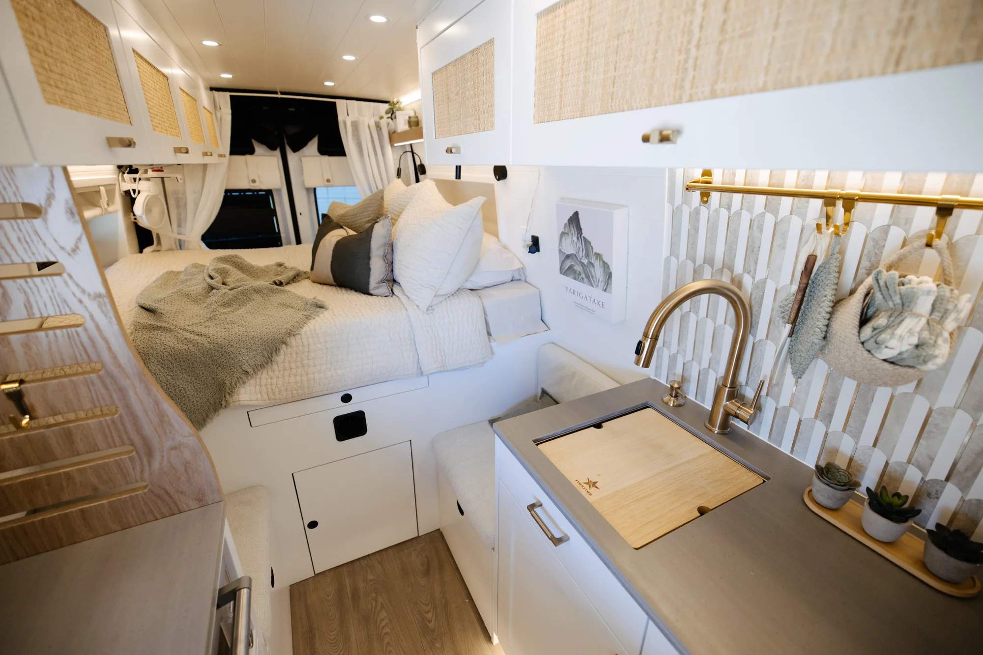 The Drifter 101 custom Ford Transit campervan built for Alison by Drifter Vans, Nomadik layout with a Japandi interior, white cabinetry, gold rain shower, and marble wet bath