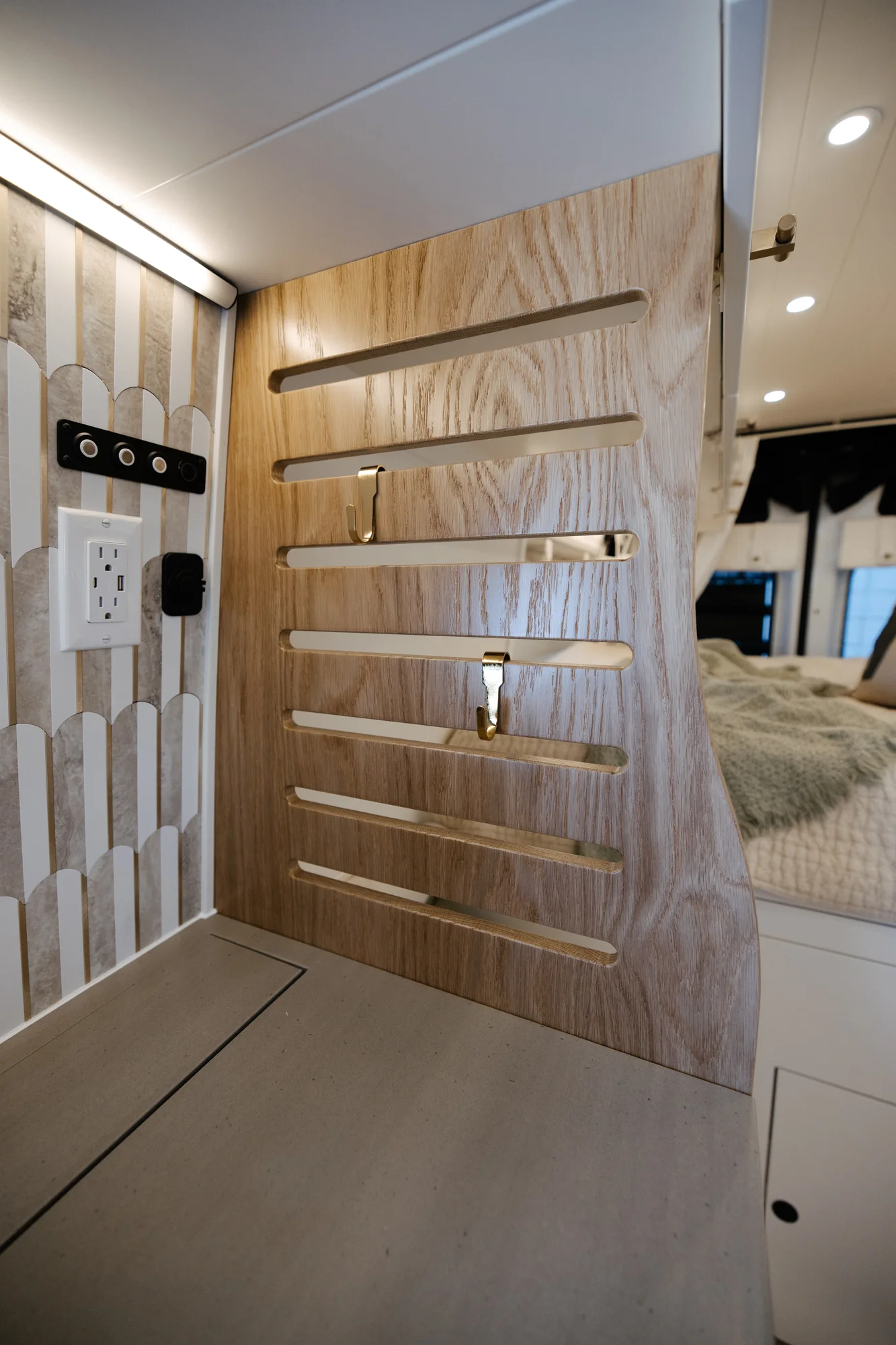The Drifter 101 custom Ford Transit campervan built for Alison by Drifter Vans, Nomadik layout with a Japandi interior, white cabinetry, gold rain shower, and marble wet bath