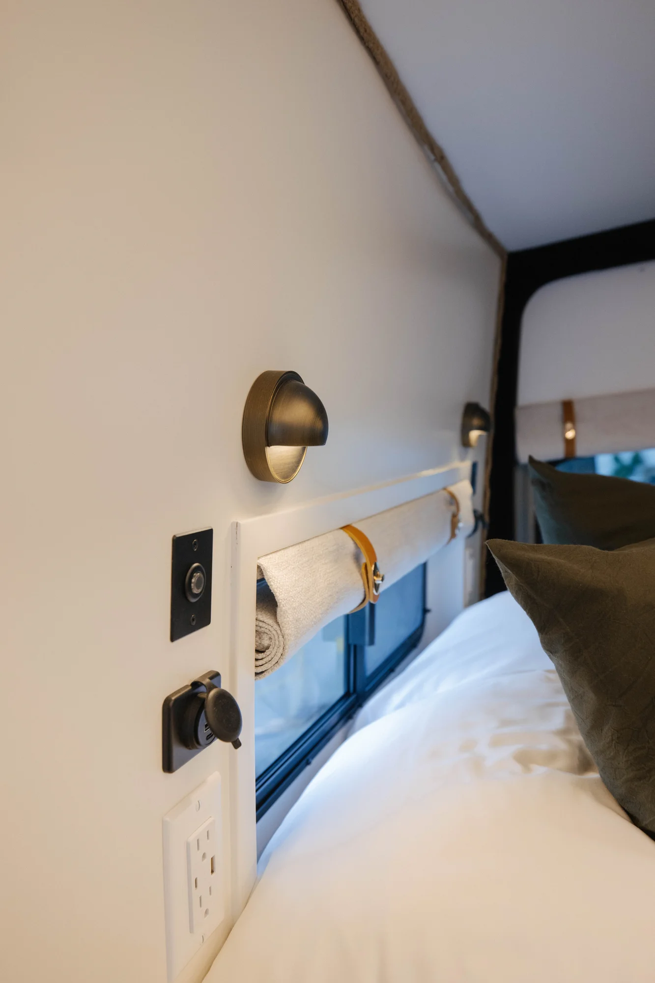 The Drifter 101 custom Mercedes-Benz Sprinter campervan built for Amber by Drifter Vans, with a pop-top sleeping area, navy cabinetry, butcher block counters, and gold hardware