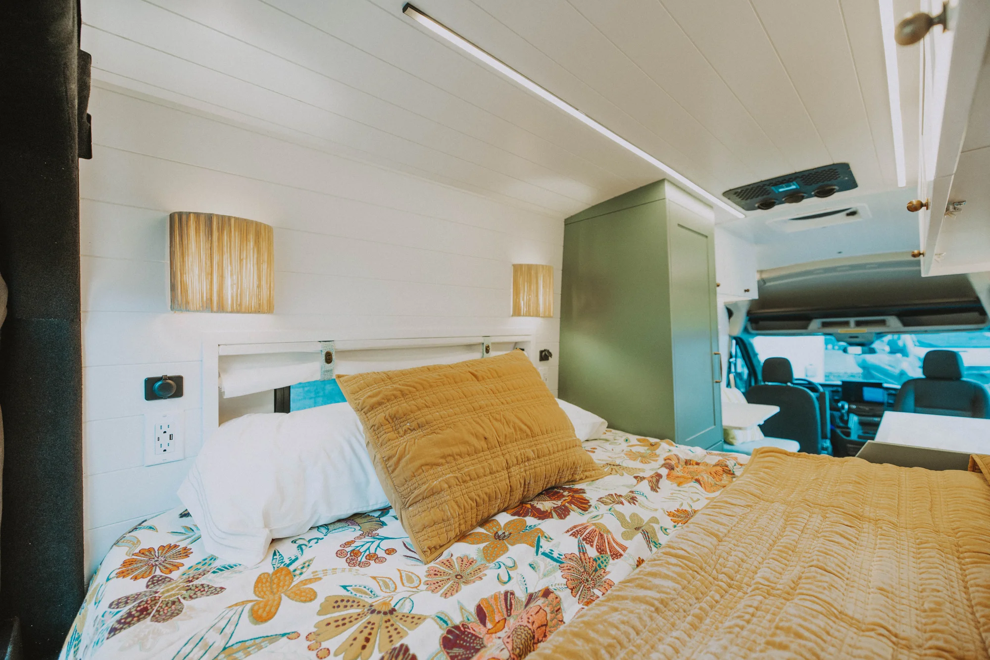 The Drifter 101 custom Ford Transit campervan built for Kristina by Drifter Vans, Drifter layout with a Moroccan-inspired blue tile backsplash, warm wood cabinetry, and a built-in dog nook
