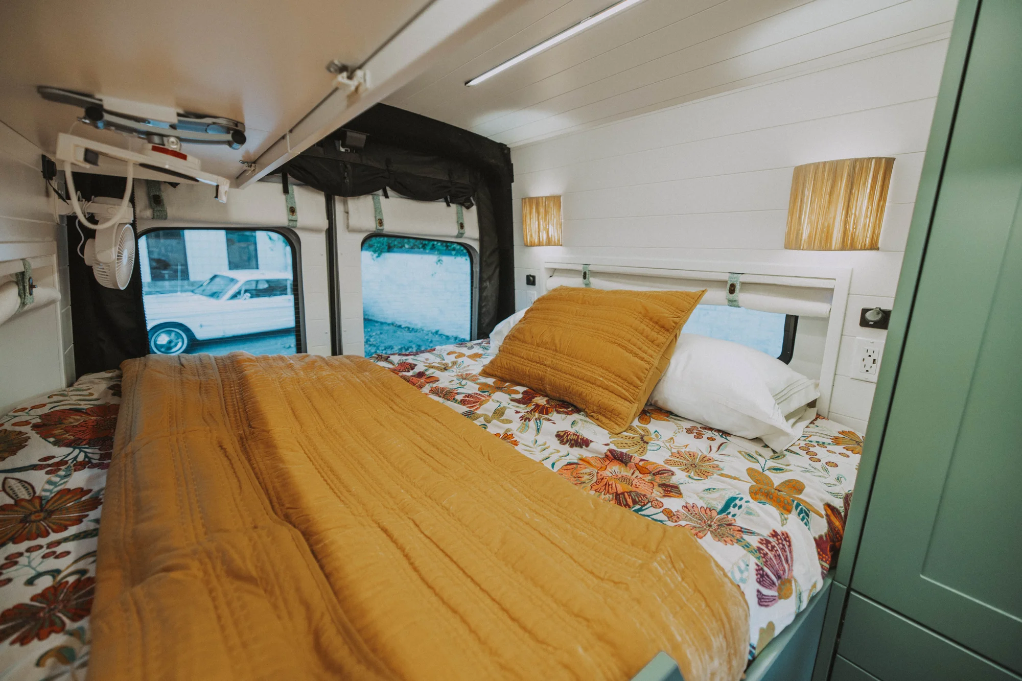 The Drifter 101 custom Ford Transit campervan built for Kristina by Drifter Vans, Drifter layout with a Moroccan-inspired blue tile backsplash, warm wood cabinetry, and a built-in dog nook