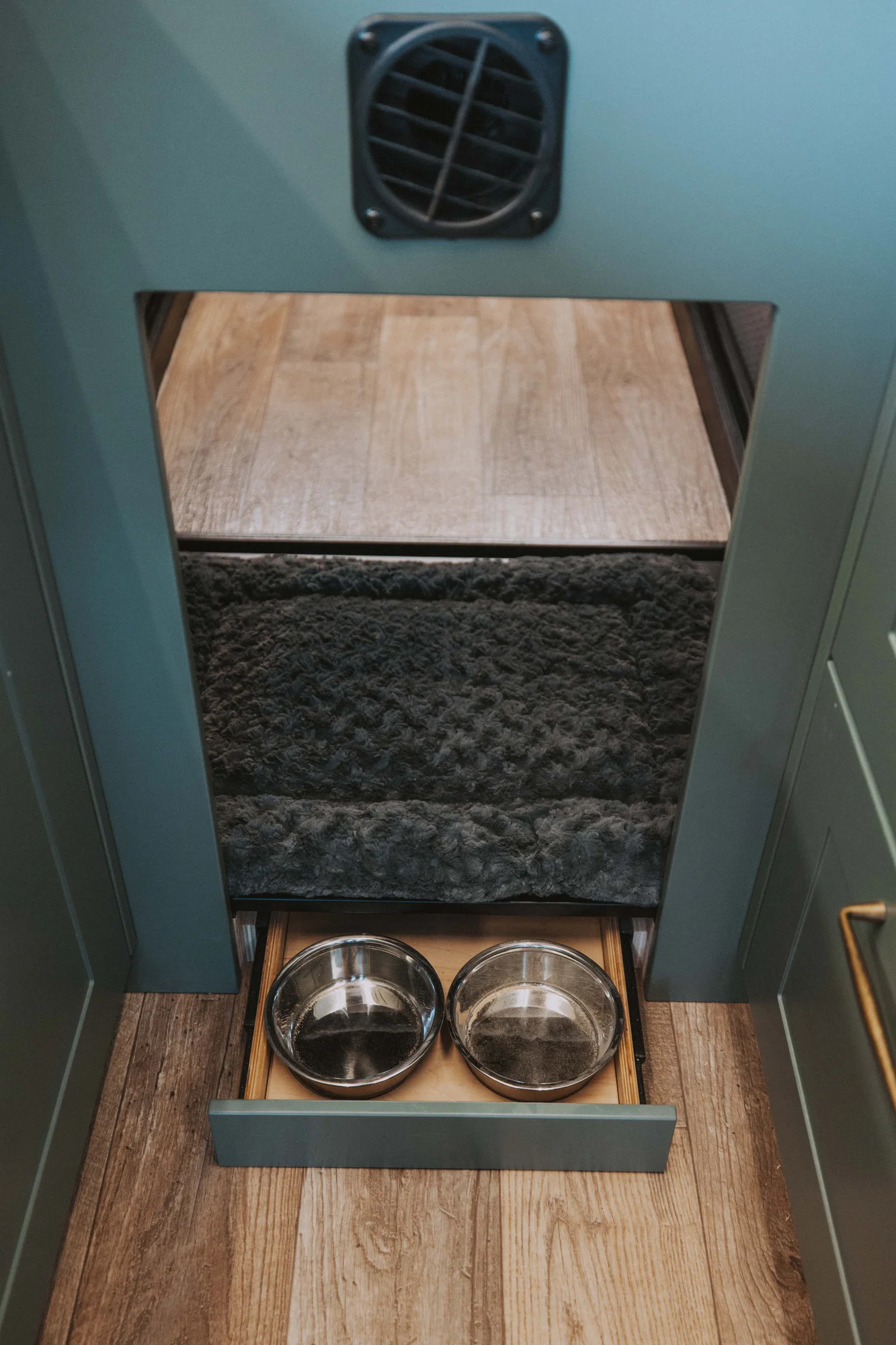 The Drifter 101 custom Ford Transit campervan built for Kristina by Drifter Vans, Drifter layout with a Moroccan-inspired blue tile backsplash, warm wood cabinetry, and a built-in dog nook