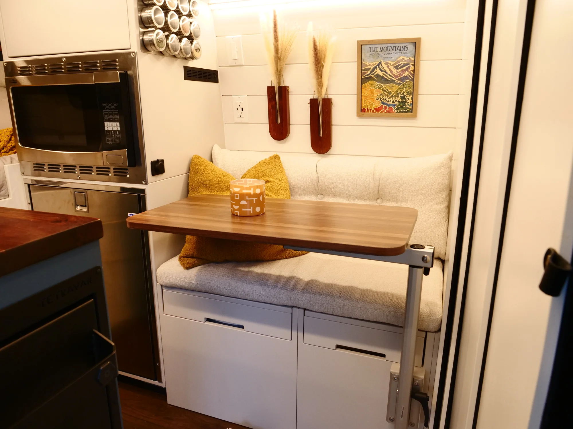 The Drifter 101 custom Ford Transit campervan built for Lynne by Drifter Vans, Drifter layout with a mid-century modern interior, dark walnut countertop, and gold hardware