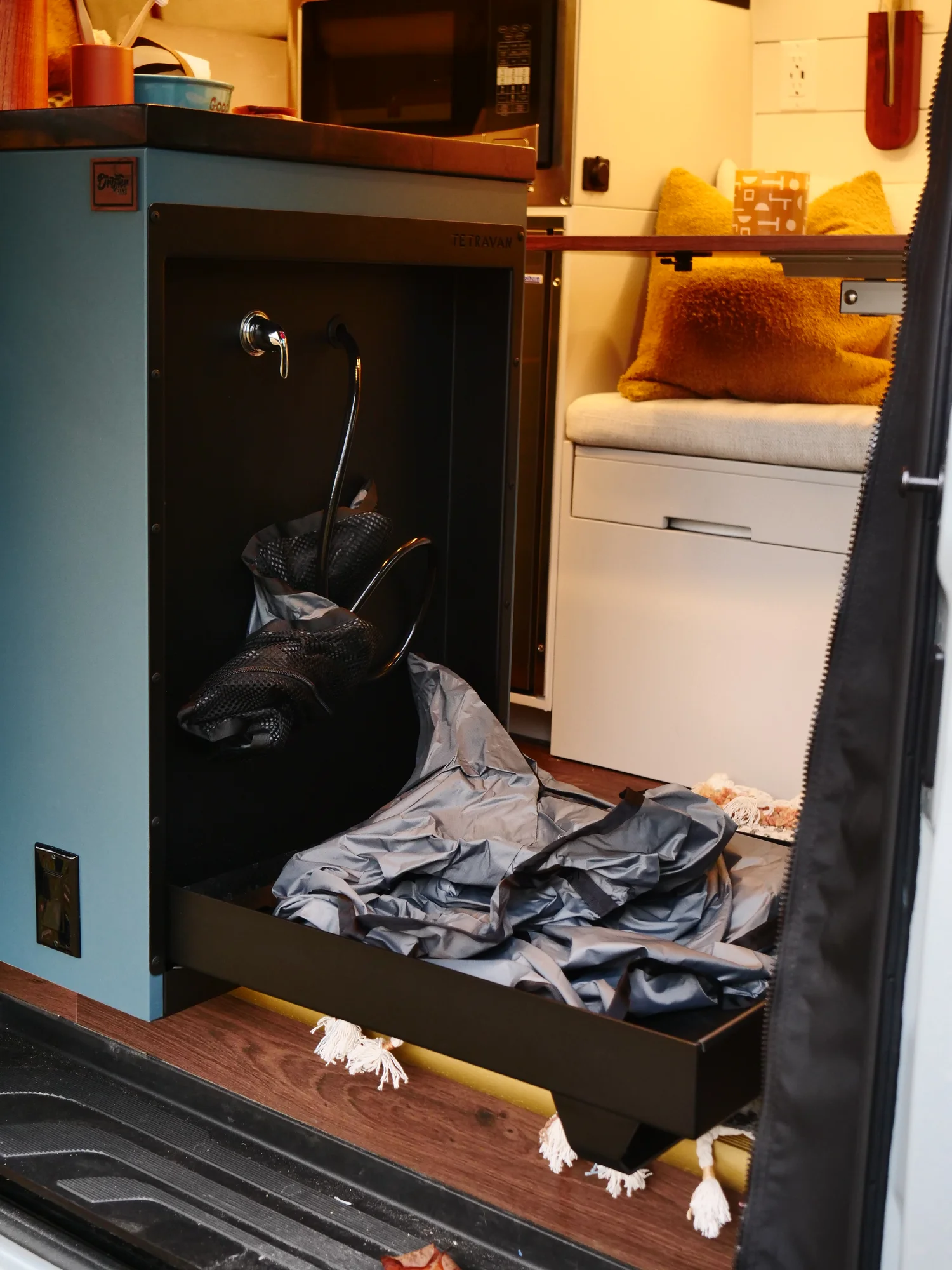 The Drifter 101 custom Ford Transit campervan built for Lynne by Drifter Vans, Drifter layout with a mid-century modern interior, dark walnut countertop, and gold hardware