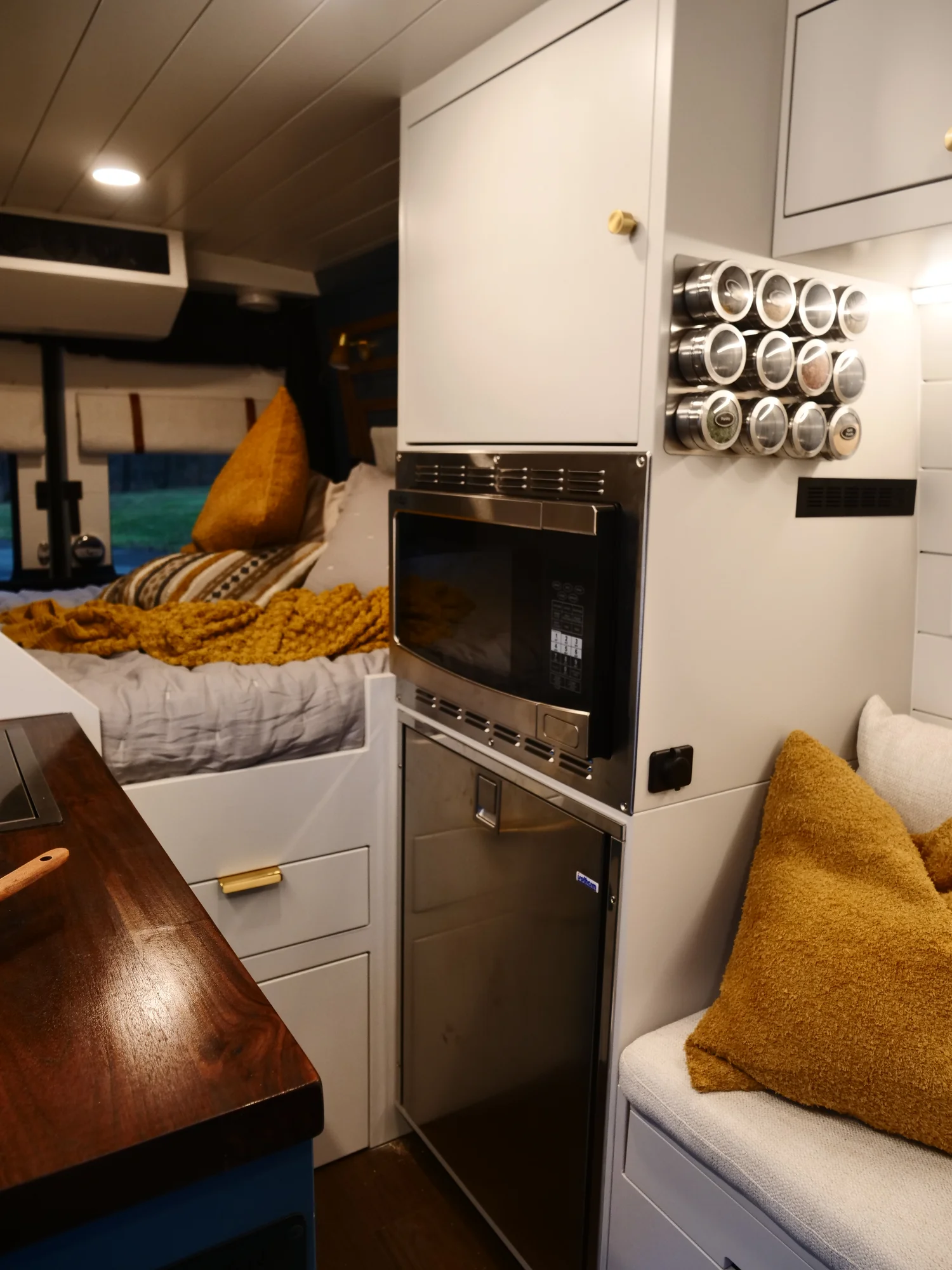 The Drifter 101 custom Ford Transit campervan built for Lynne by Drifter Vans, Drifter layout with a mid-century modern interior, dark walnut countertop, and gold hardware