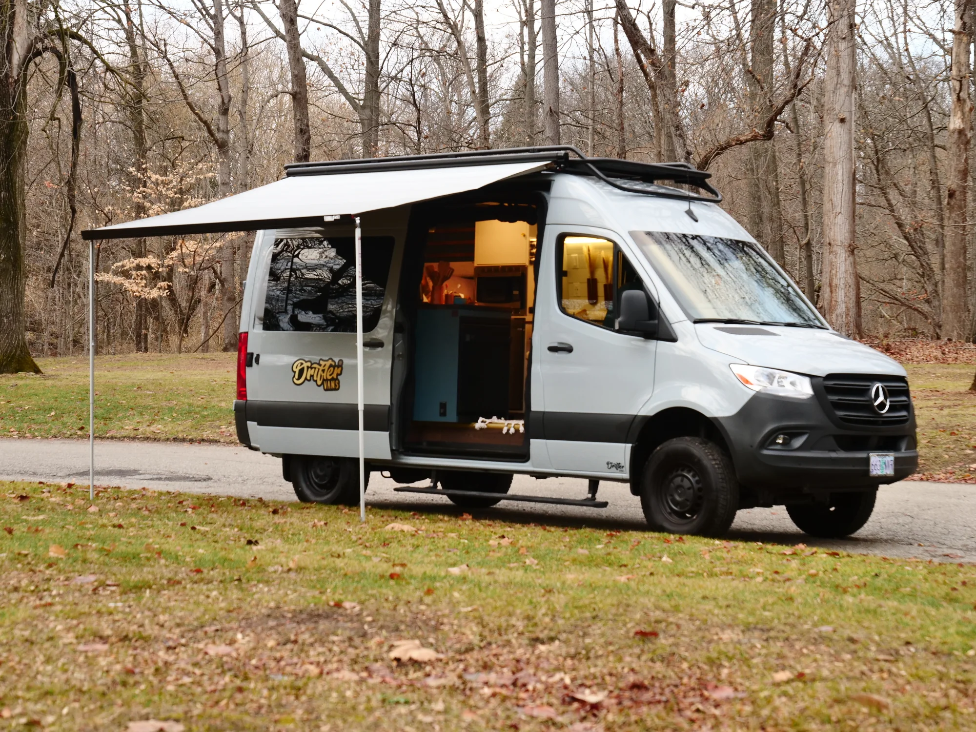 The Drifter 101 custom Ford Transit campervan built for Lynne by Drifter Vans, Drifter layout with a mid-century modern interior, dark walnut countertop, and gold hardware
