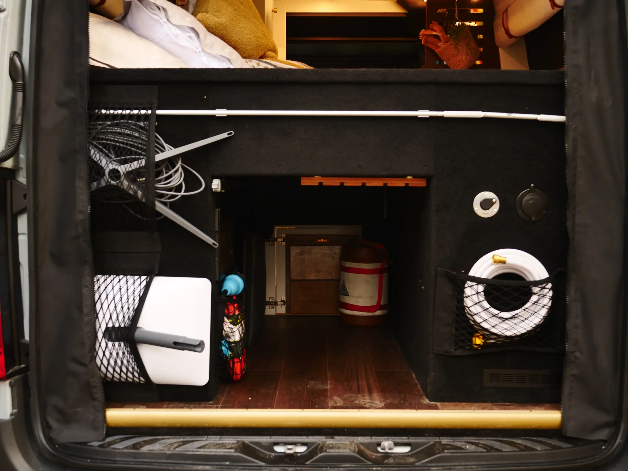 The Drifter 101 custom Ford Transit campervan built for Lynne by Drifter Vans, Drifter layout with a mid-century modern interior, dark walnut countertop, and gold hardware