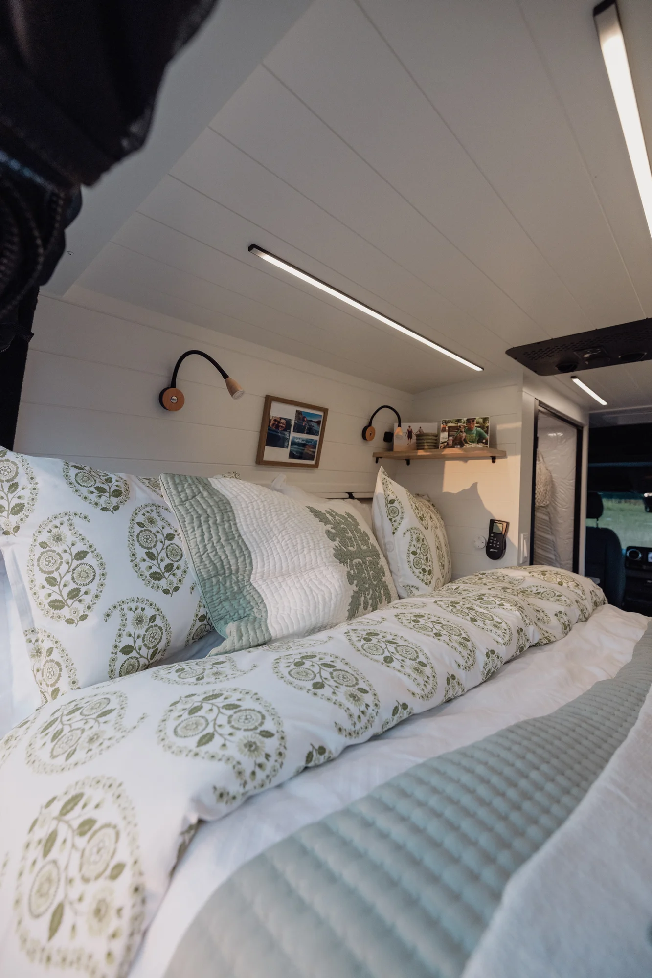 The Drifter 101 custom Mercedes-Benz Sprinter campervan built for Tanya by Drifter Vans, rustic interior with light blue cabinetry, butcher block countertop, and oil-rubbed bronze fixtures