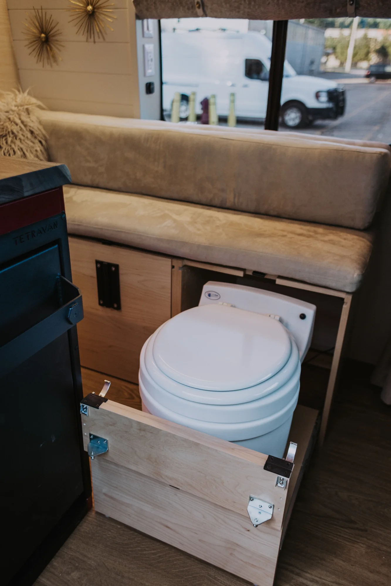 The Drifter 101 custom Ford Transit campervan built for Kim by Drifter Vans, Drifter layout with floral bedding, wood ceiling, and black shower fixtures