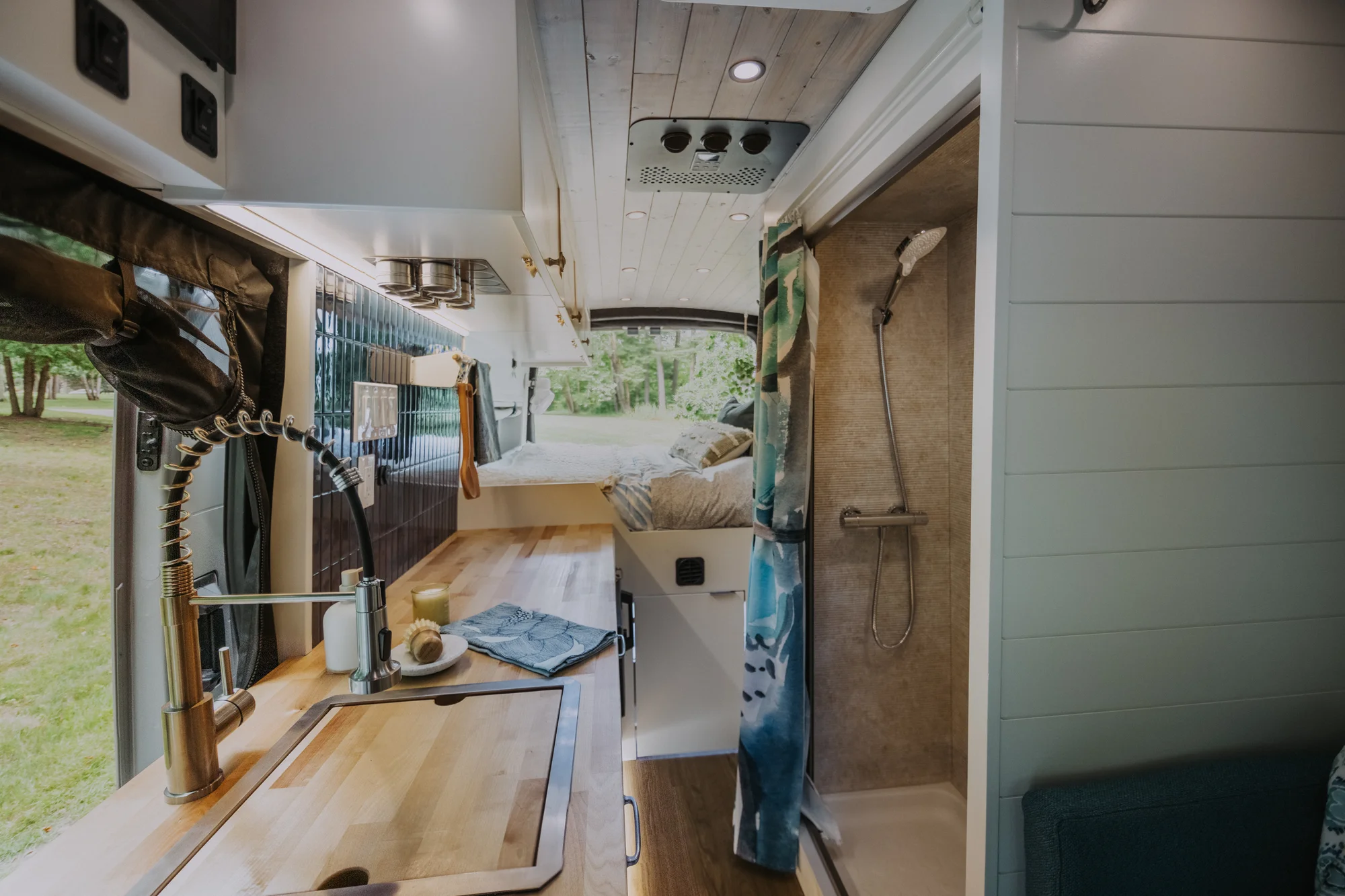The Drifter 101 custom Ford Transit campervan built for Peter and Linka by Drifter Vans, Scout layout with a coastal interior, light finishes, EcoFlow off-grid power, and a remote work setup