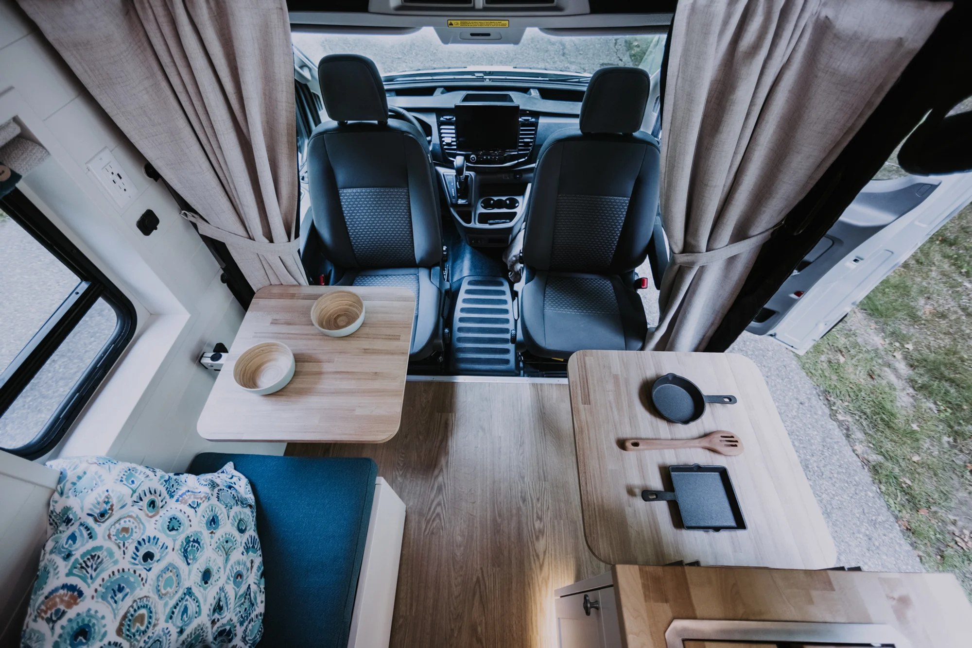 The Drifter 101 custom Ford Transit campervan built for Peter and Linka by Drifter Vans, Scout layout with a coastal interior, light finishes, EcoFlow off-grid power, and a remote work setup