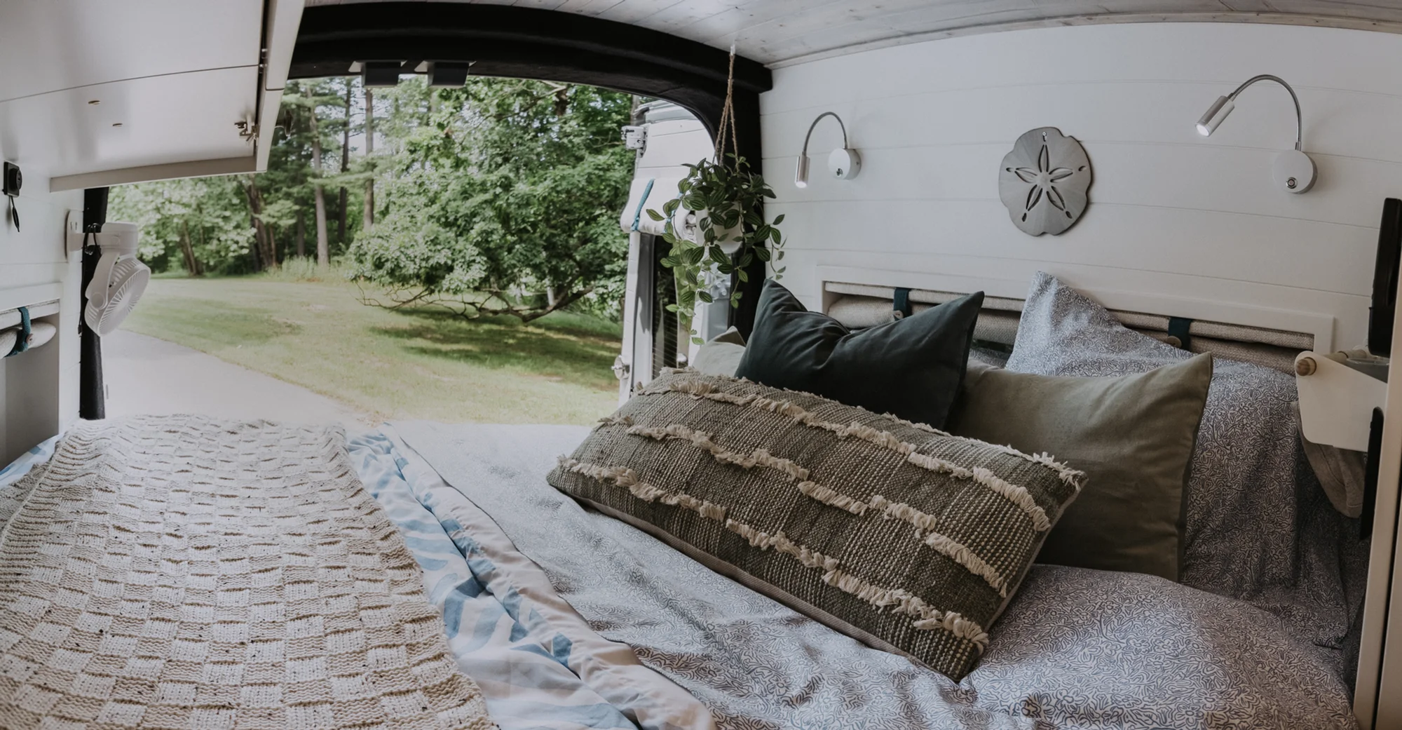 The Drifter 101 custom Ford Transit campervan built for Peter and Linka by Drifter Vans, Scout layout with a coastal interior, light finishes, EcoFlow off-grid power, and a remote work setup