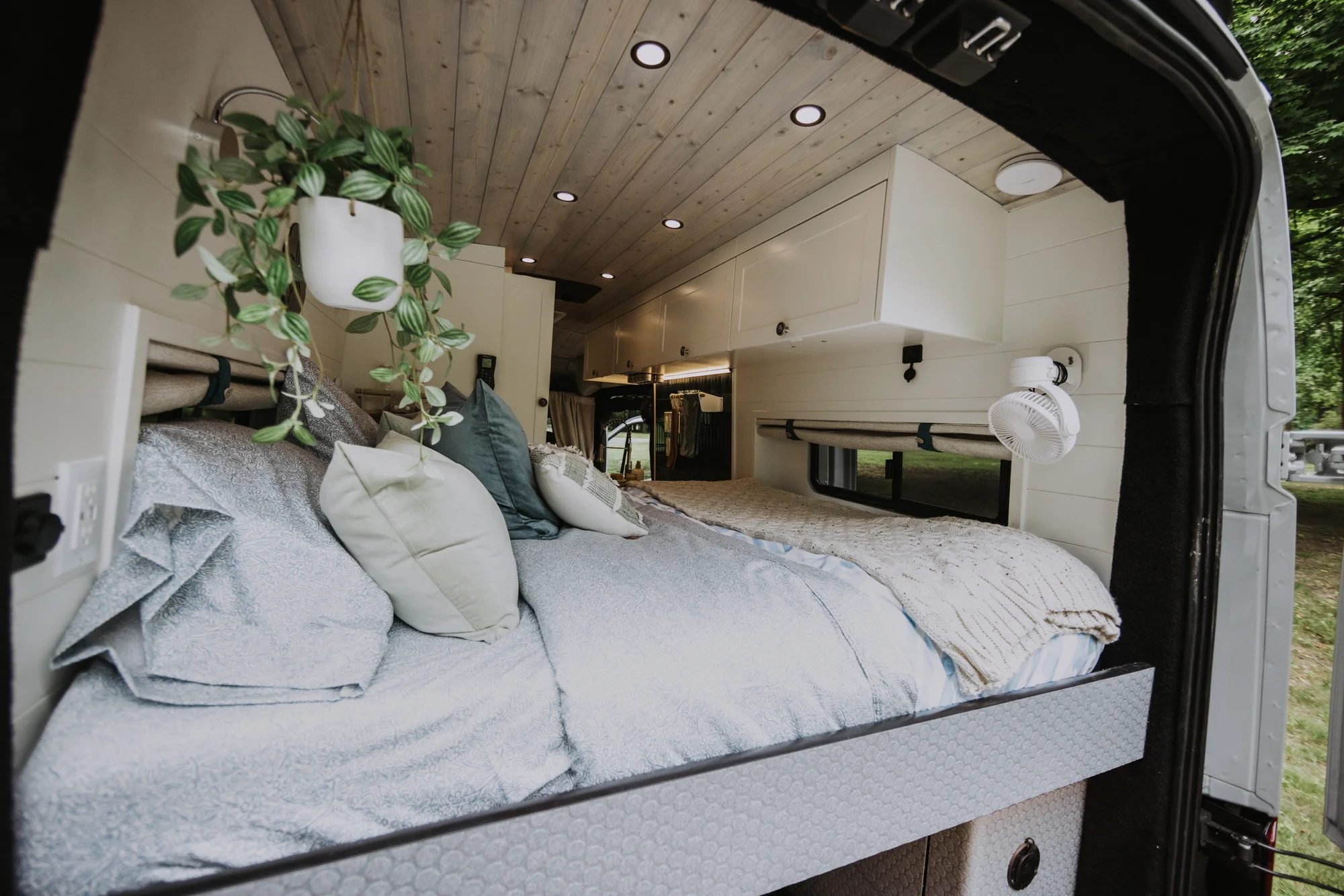 The Drifter 101 custom Ford Transit campervan built for Peter and Linka by Drifter Vans, Scout layout with a coastal interior, light finishes, EcoFlow off-grid power, and a remote work setup